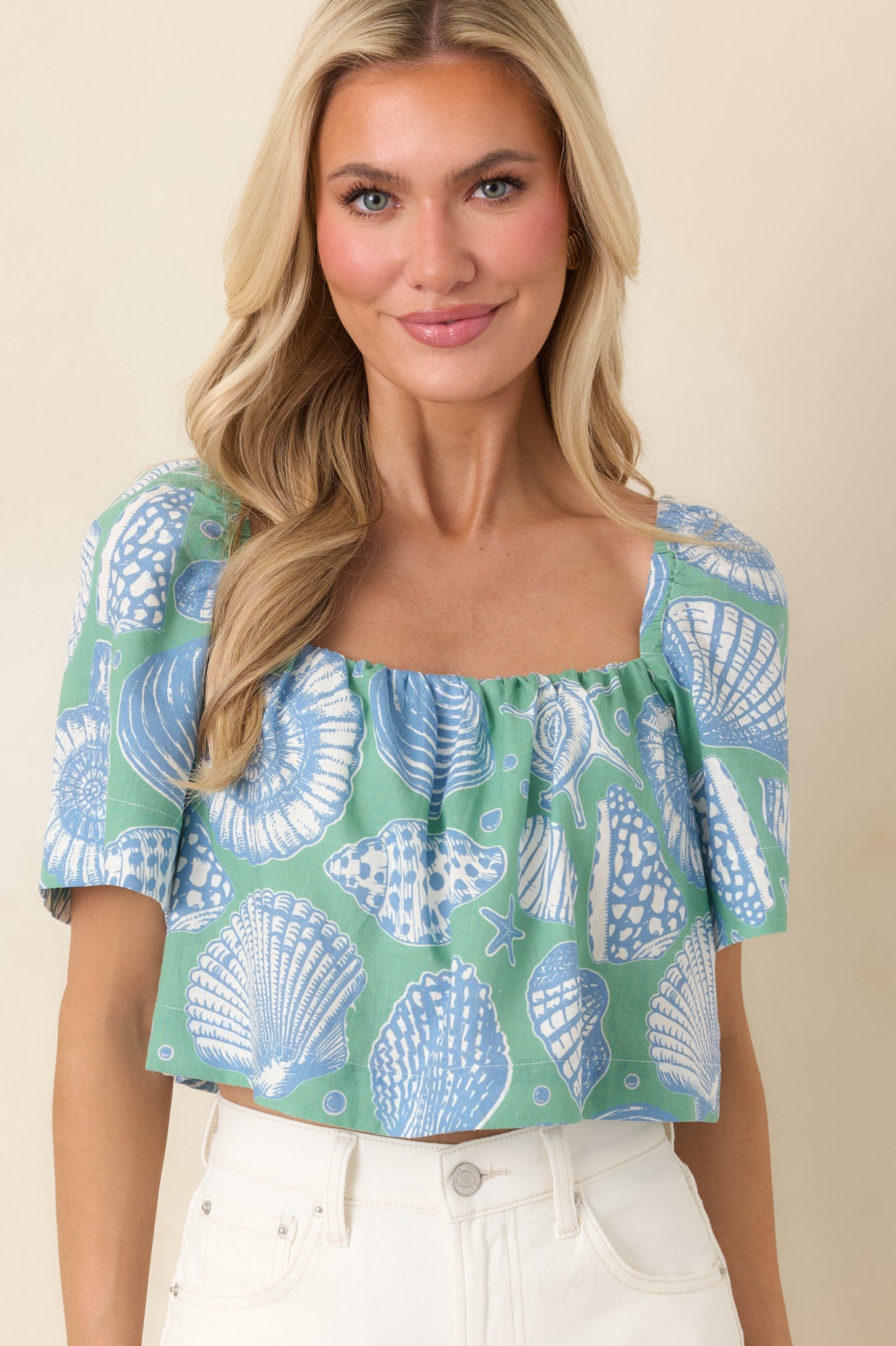 Close-cropped image emphasizing the elasticized square neckline and gathered detailing.