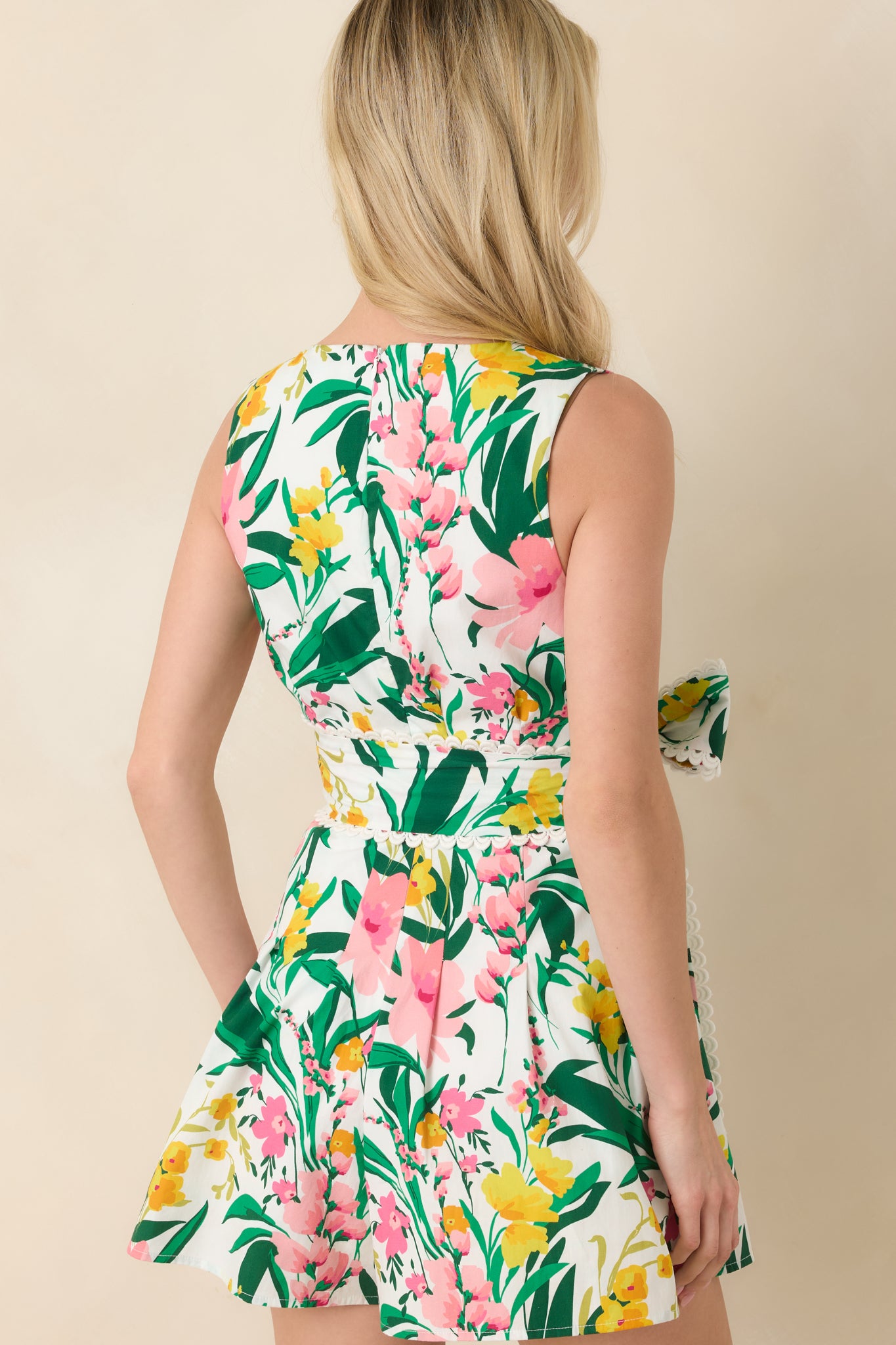 Rear view of the tropical romper showing the flared shorts, vibrant floral print, and smooth cotton fabric for a breezy fit.