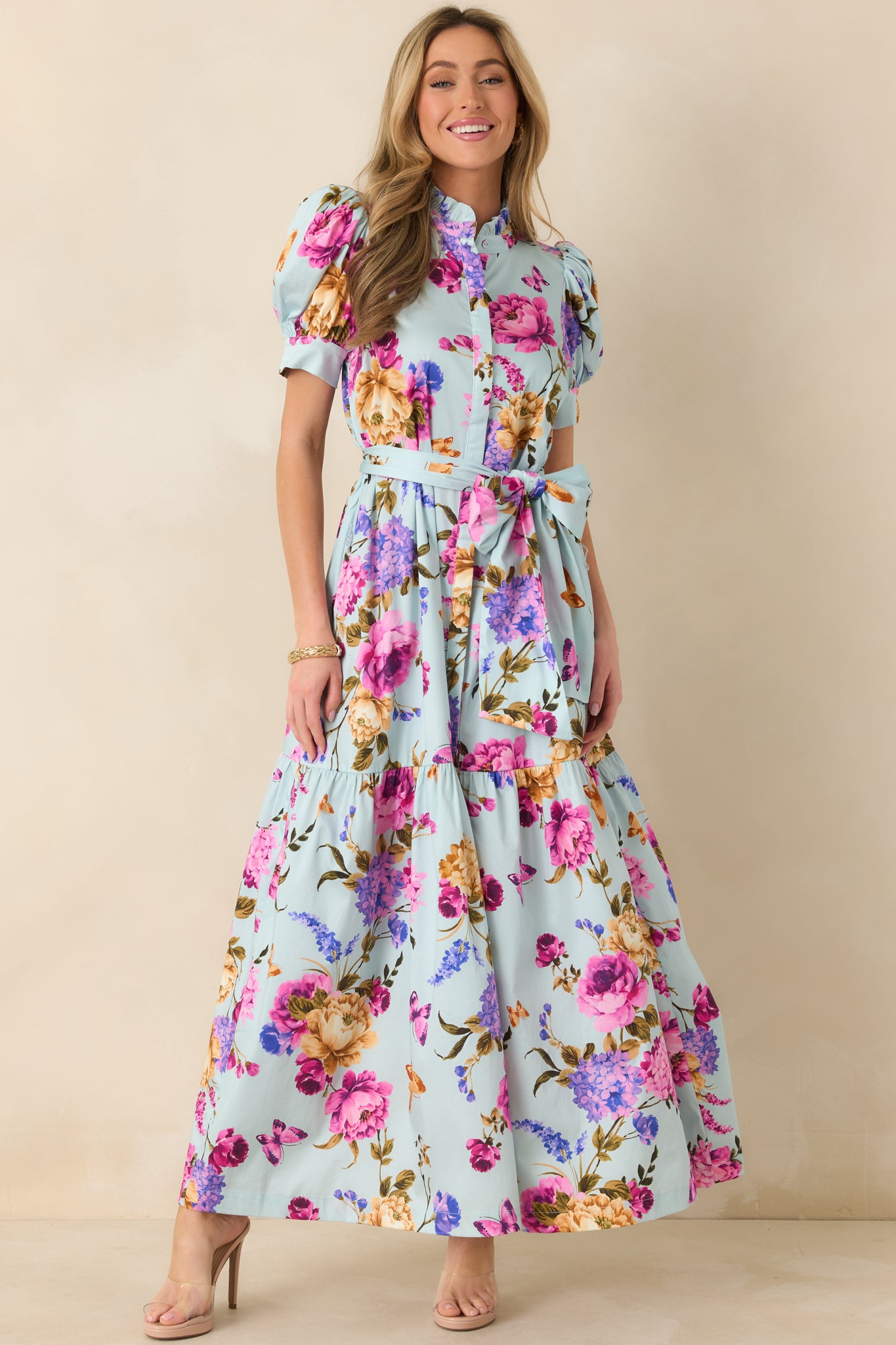 Angled front view highlighting the button-front bodice and adjustable self-tie belt at the waist.