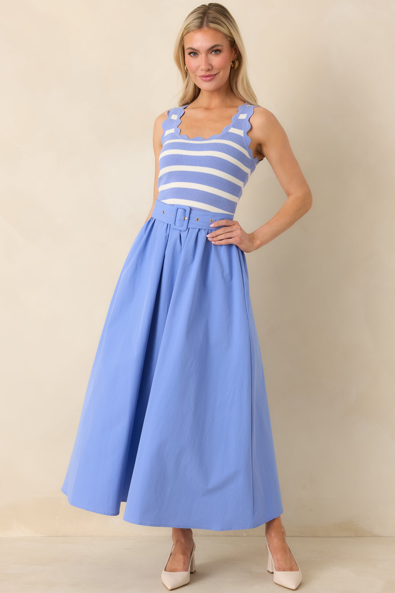 Straight-on front view emphasizing the functional side pockets and smooth solid blue skirt.