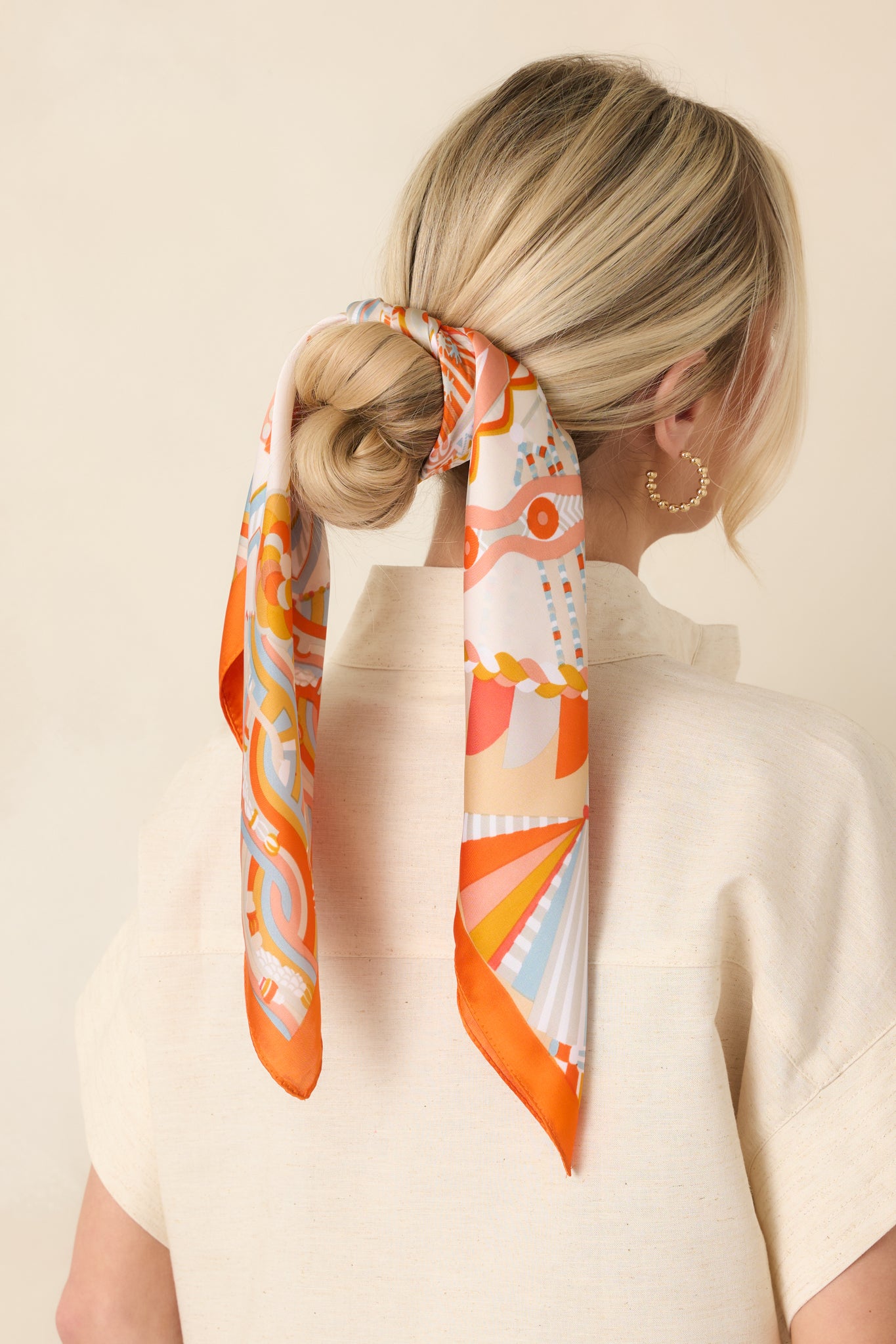 Lightweight scarf showing backside of vibrant geometric design and clean edges.