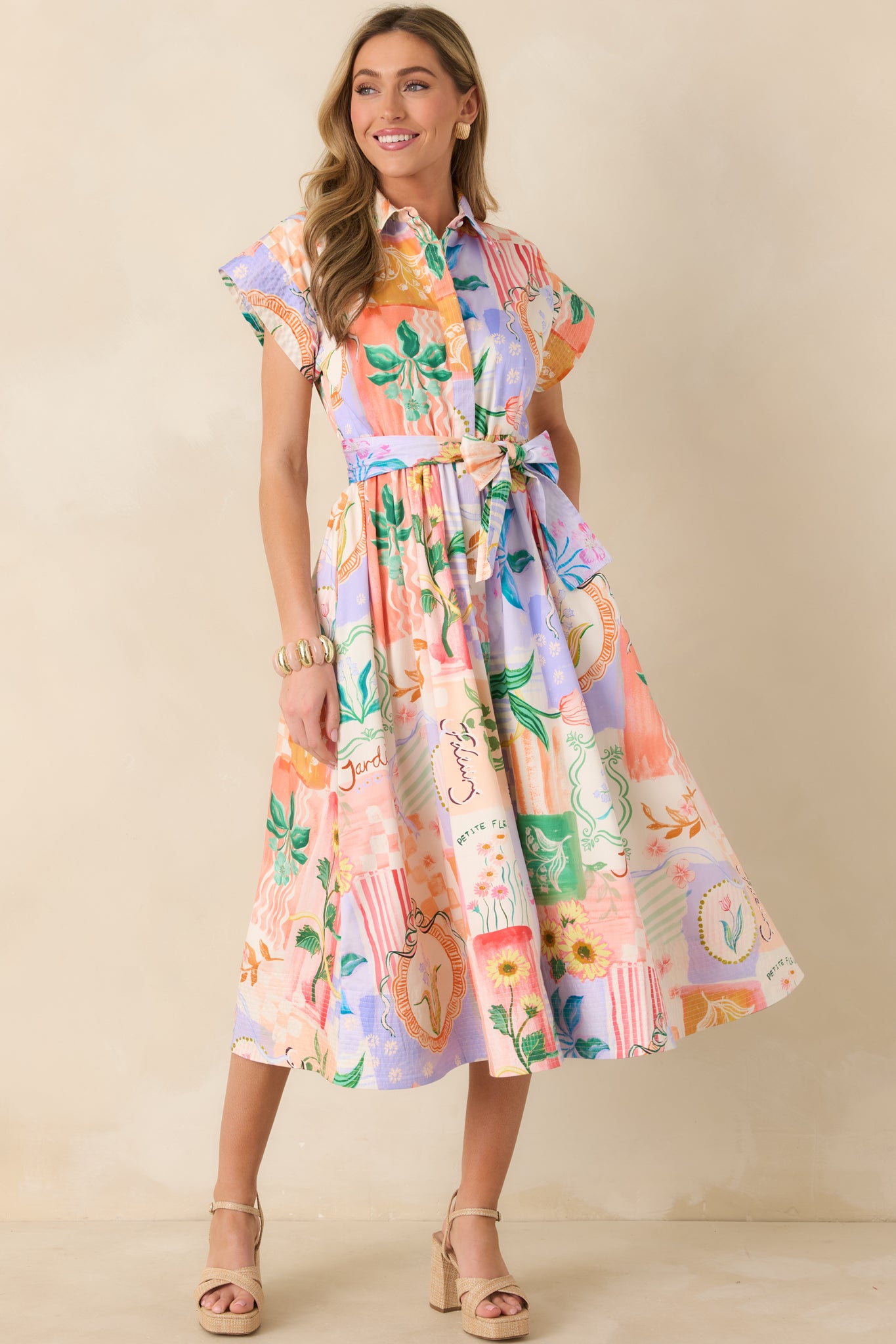Lightweight cotton midi dress in a peach floral print with collared neckline, front buttons, and a gently flared hem.