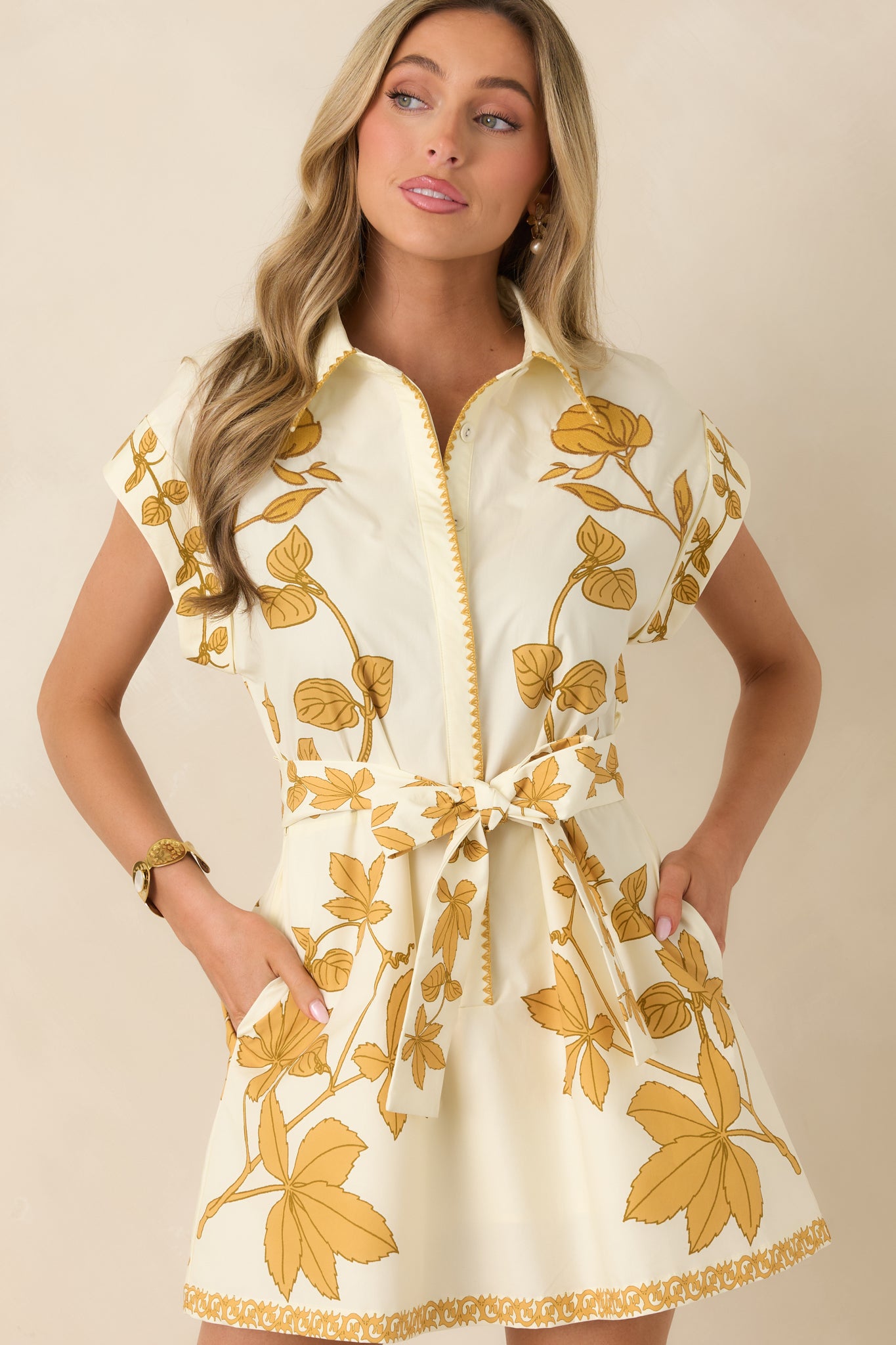 Cropped view of upper bodice showing tailored collar, button-front placket, and floral print on cotton fabric.