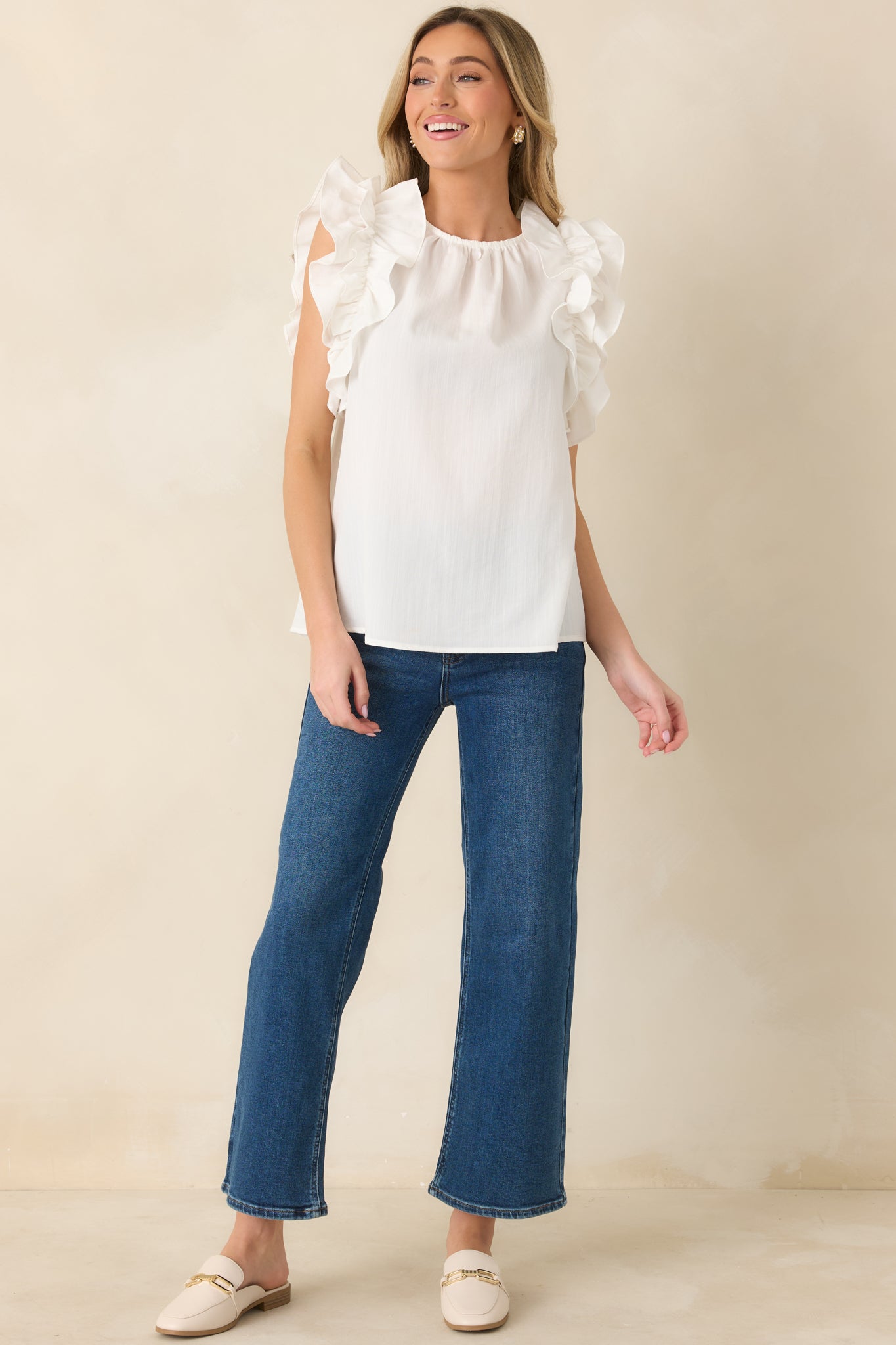 Dark wash cropped jeans featuring structured waistband, classic five-pocket design, and front button closure.