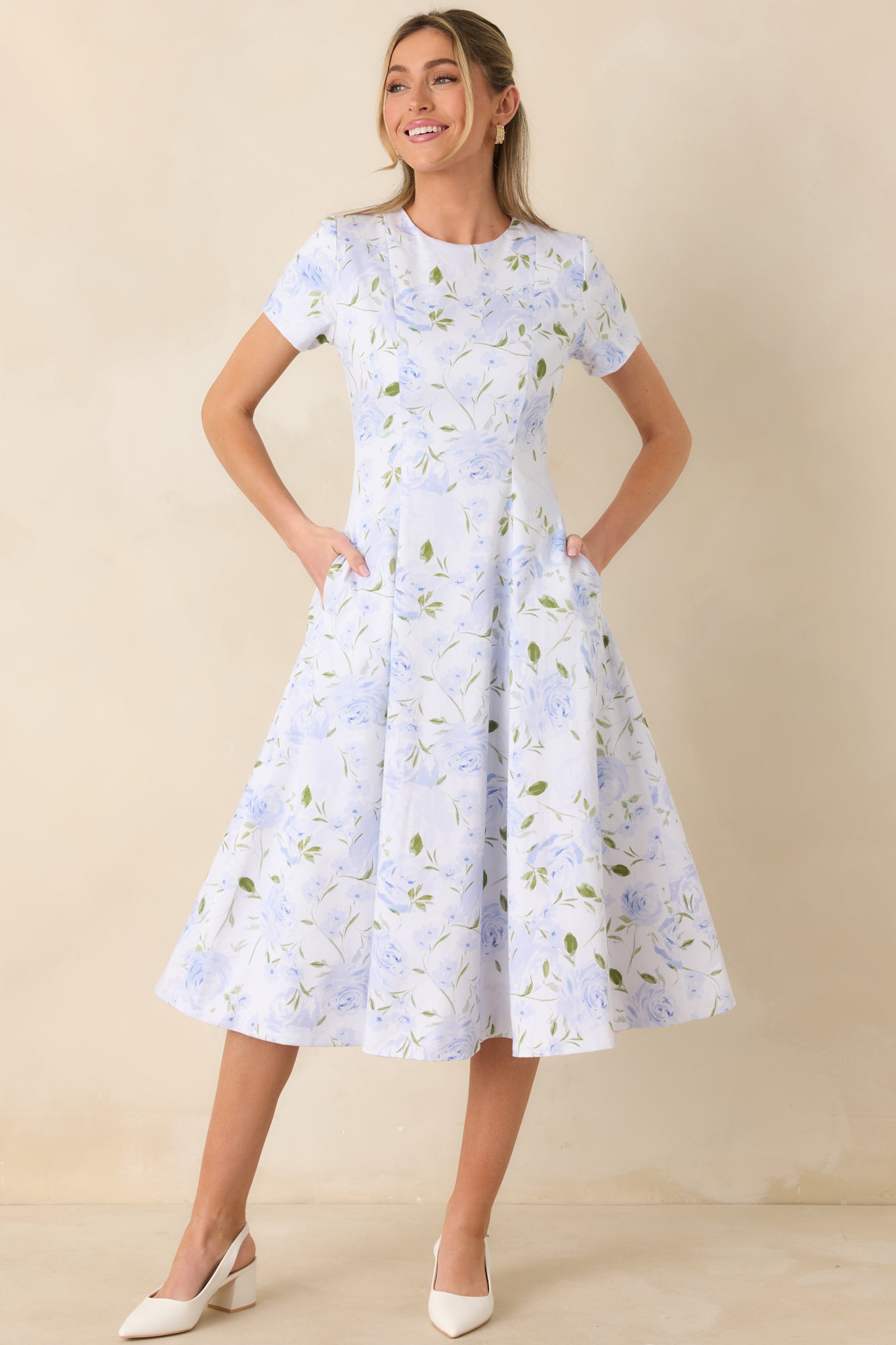 Blue floral print midi dress designed with a tailored bodice and fluid skirt that falls below the knee.