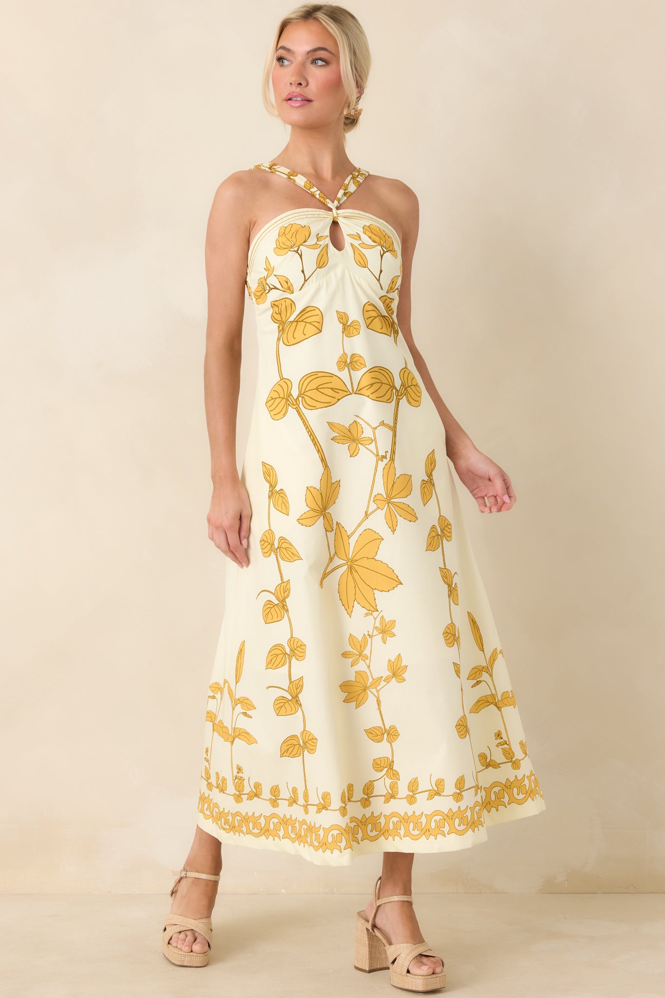 Front-facing view emphasizing halter keyhole detail, flattering fitted bodice, and polished full-length skirt.