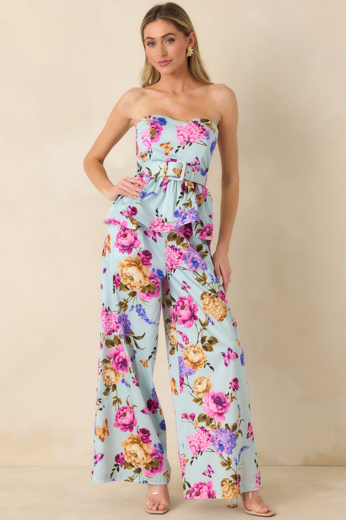 Blue multicolored strapless top with sweetheart neckline, fitted bodice, and flared peplum hem.