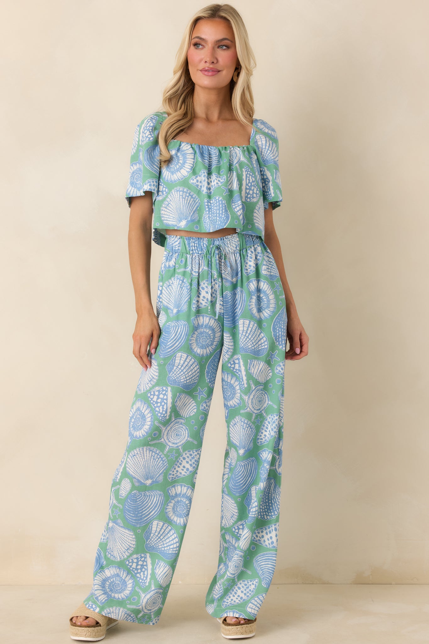 Lightweight cotton cropped top in seaglass green showcasing short draped sleeves and an airy fit.