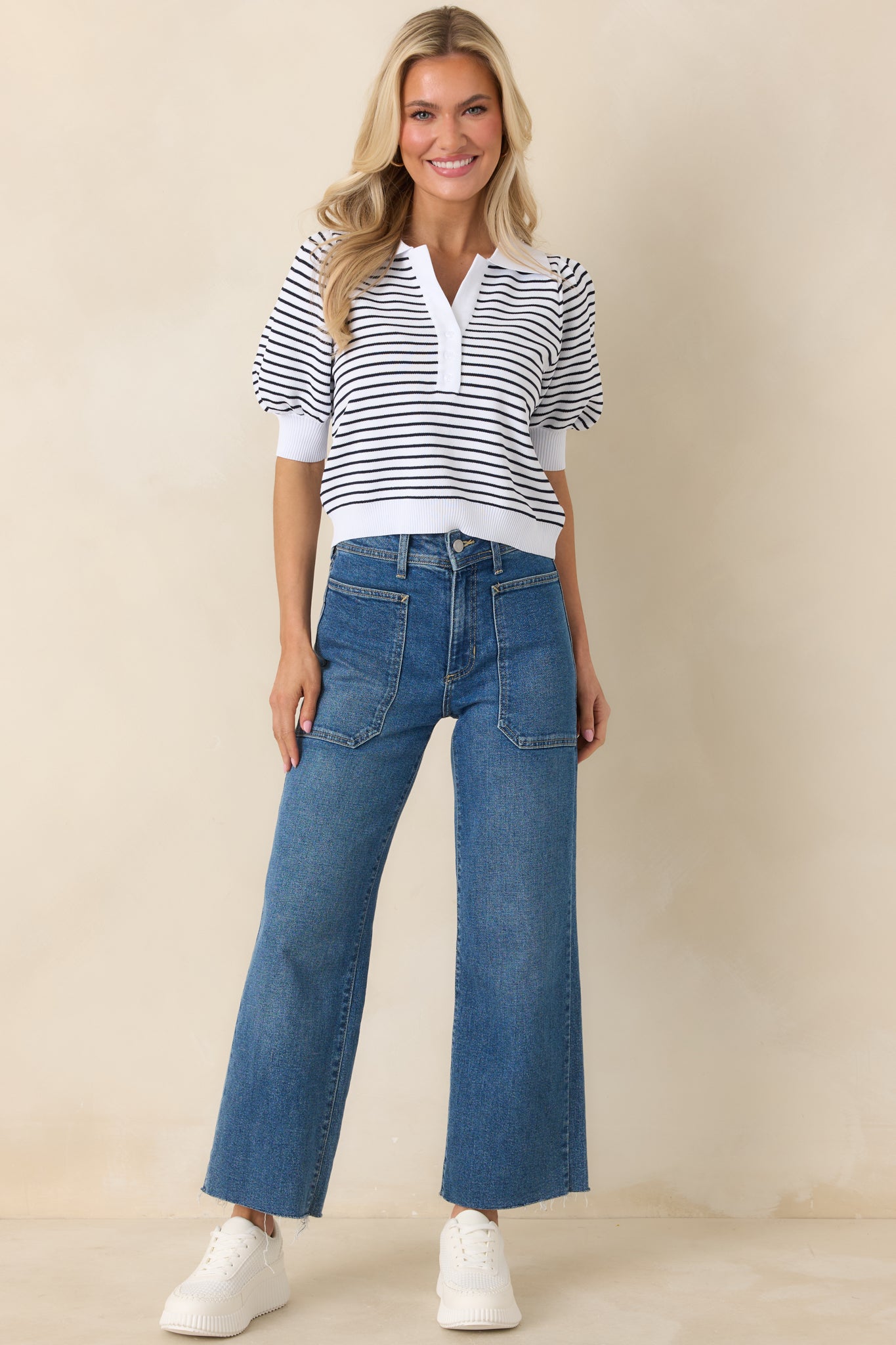 Ivory and black striped knit polo top with a collared neckline, partial button placket, and short puff sleeves.