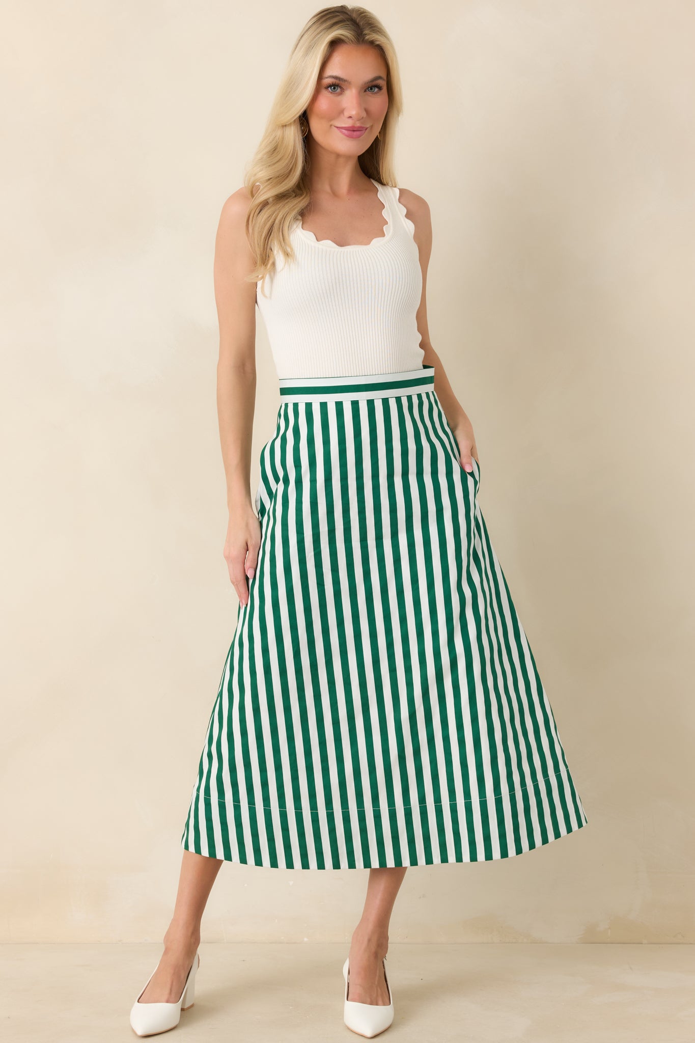 Green and ivory striped skirt highlighting the structured waistband and crisp vertical stripe pattern.