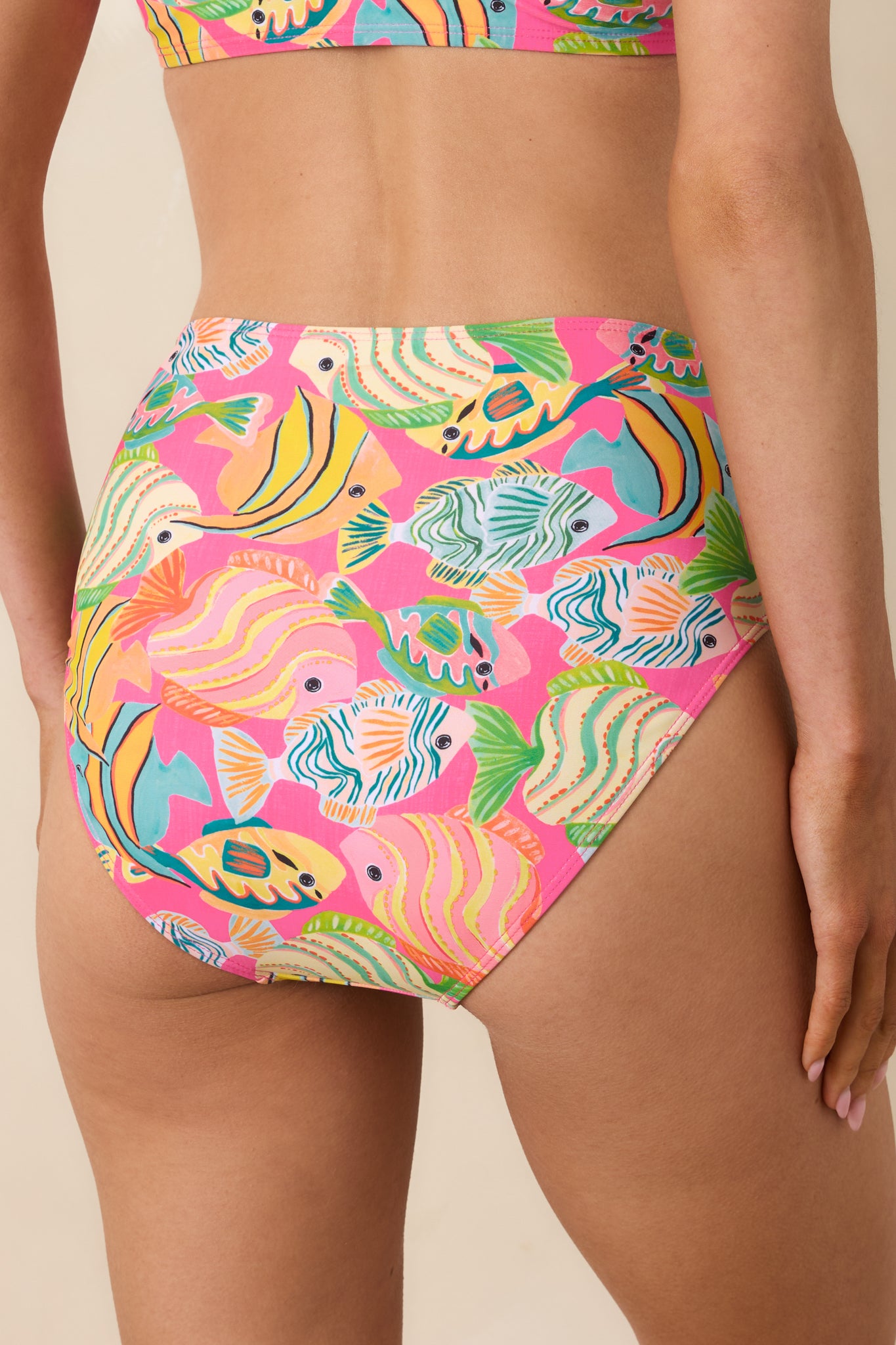 Back view of pink high-waisted bikini bottoms featuring the full tropical fish pattern and flattering coverage.