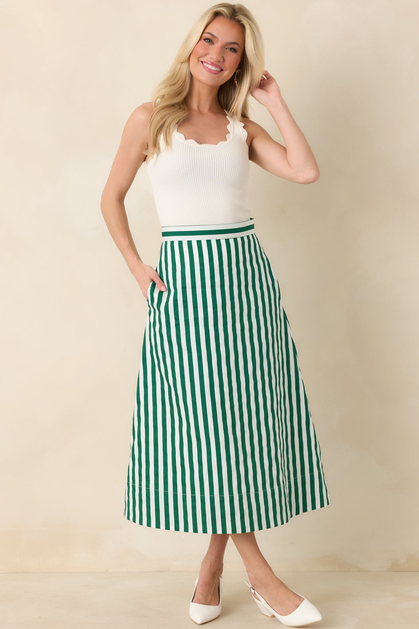 Green and ivory striped midi skirt designed with a structured waistband, clean vertical lines, and a softly flared A-line silhouette.