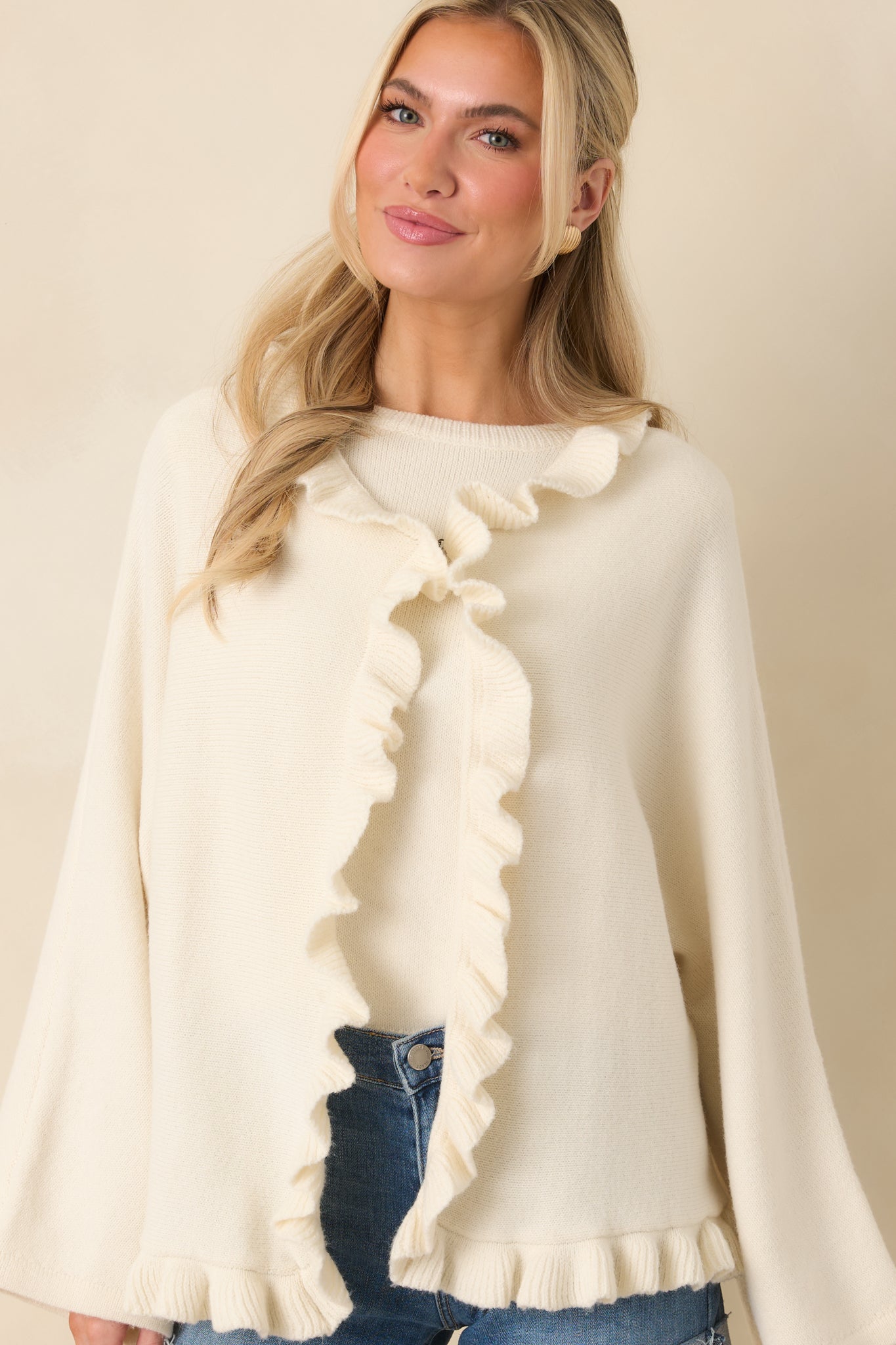 Cropped image showing the textured knit fabric and subtle drape of the relaxed-fit cardigan.