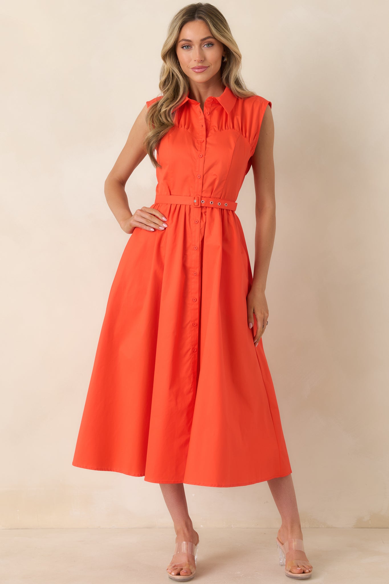 Sleeveless collared midi dress with tailored waist belt and gracefully flared skirt.