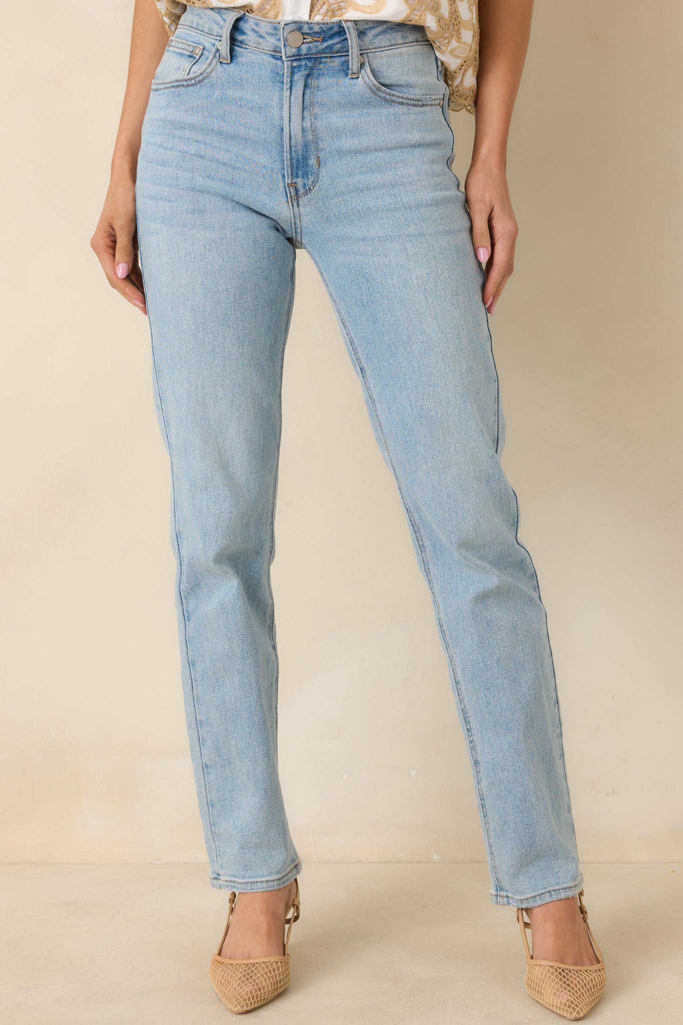 Front hip pocket detail on classic straight-leg denim pants.