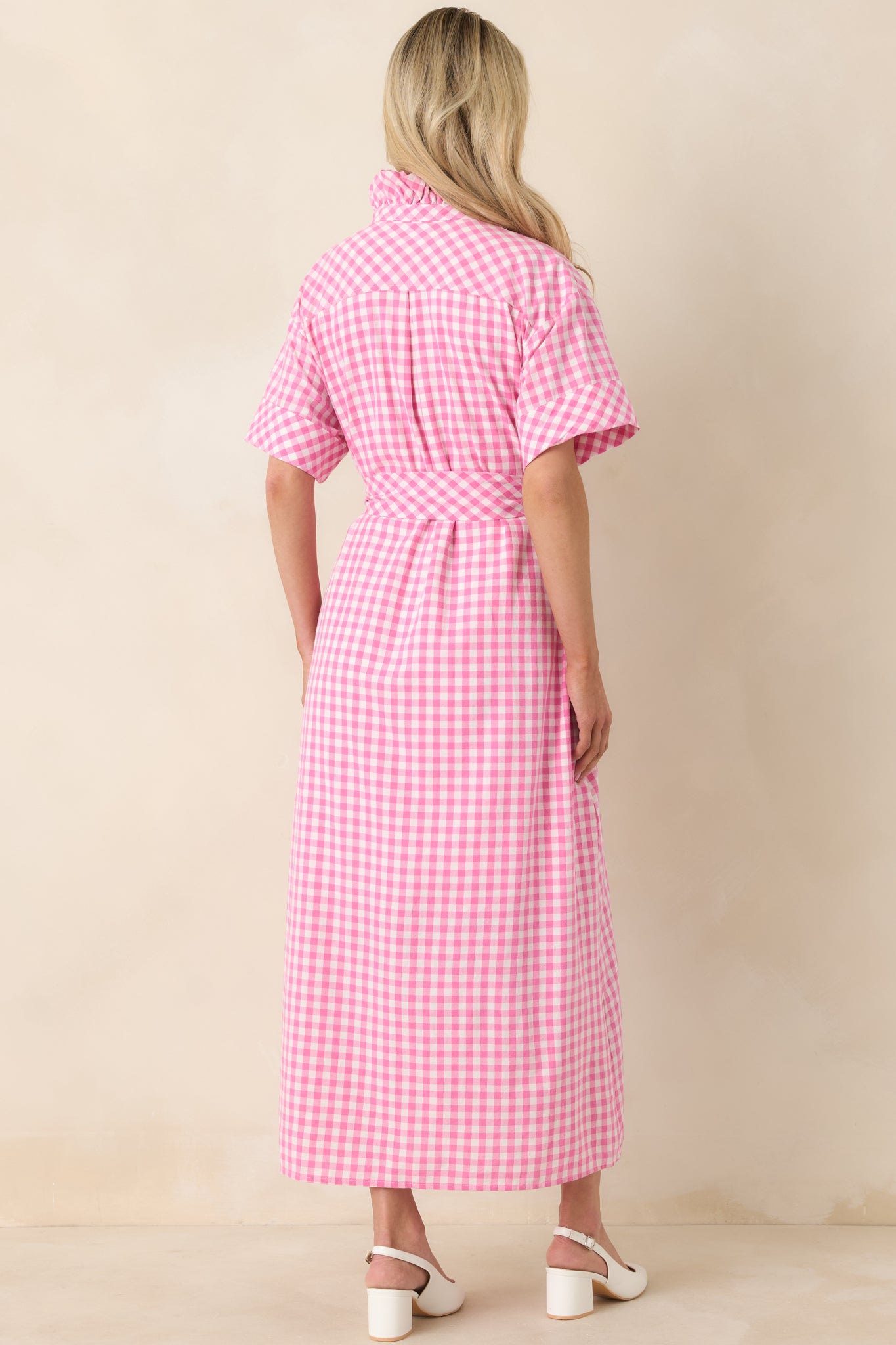 Pink and white gingham maxi dress displaying a smooth rear silhouette with short sleeves and flowing full-length skirt.