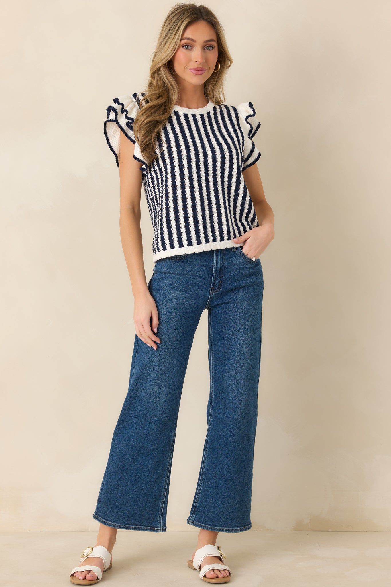 Striped top with crew neckline, flutter sleeves, and soft vertical pattern.