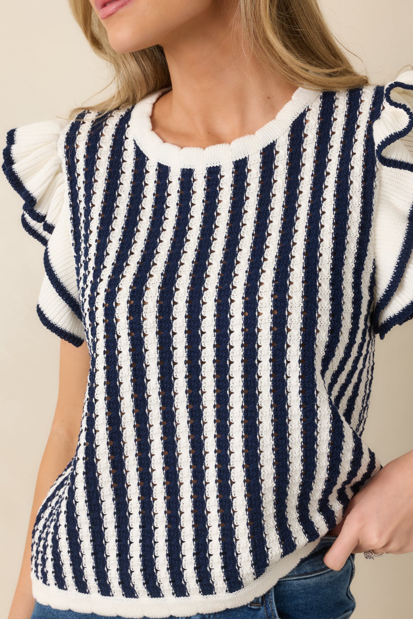 Flutter sleeves paired with vertical stripes for soft movement.