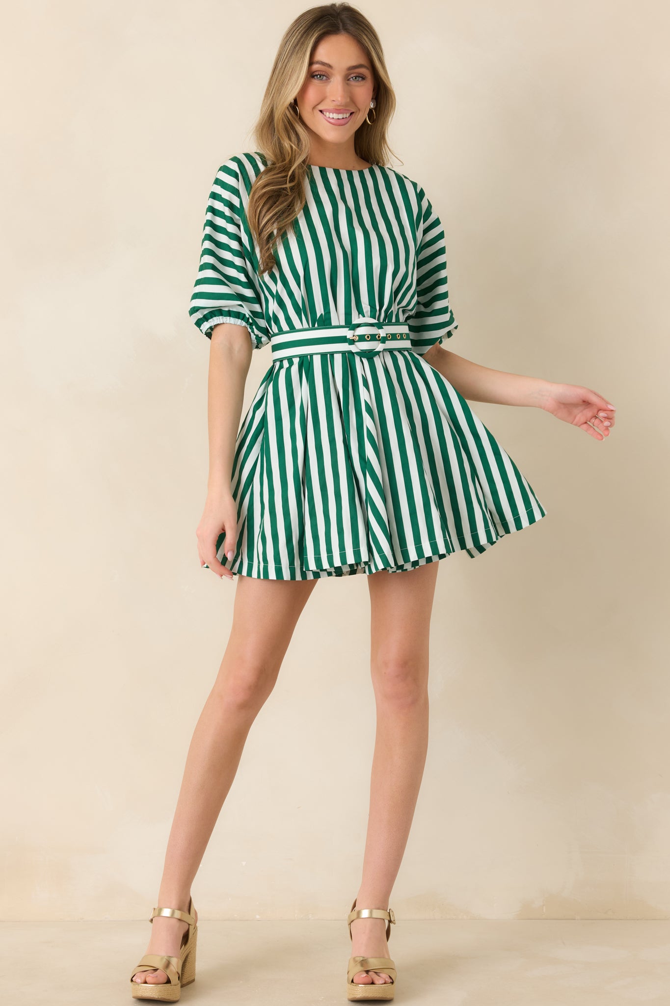 Fresh green and ivory striped mini dress designed with a relaxed swing shape, round neckline, short puff sleeves, and a waist-cinching striped belt.