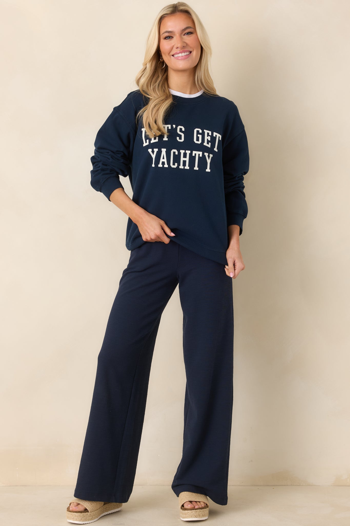 Front view of navy sweatshirt showcasing crew neckline and “Let’s Get Yachty” front graphic.