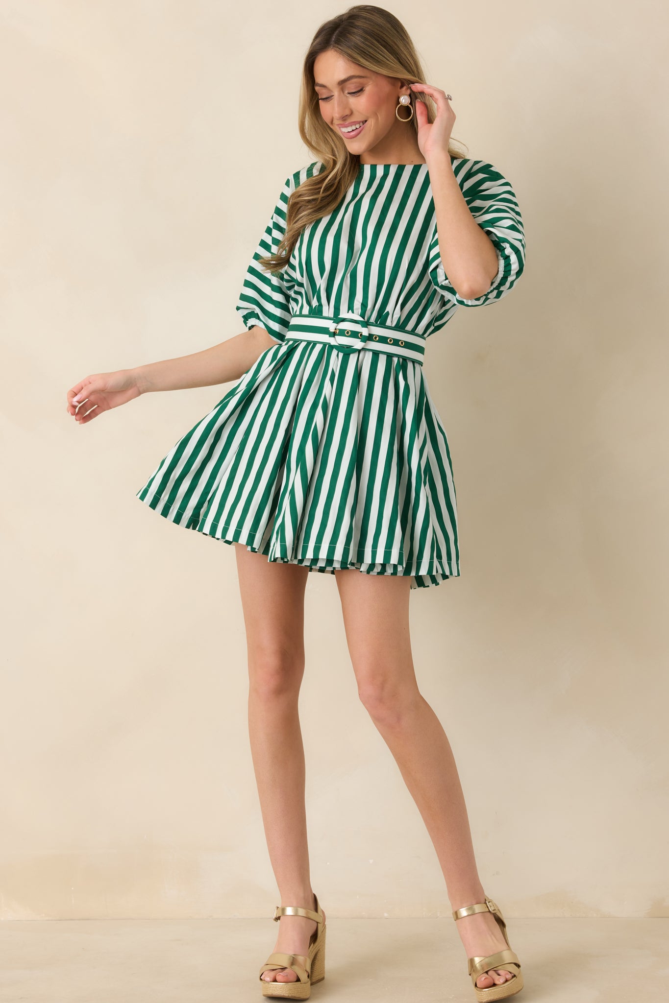 Lightweight mini dress with vertical green and ivory stripes, a round neckline, puff sleeves, and a coordinating belt creating a defined silhouette.