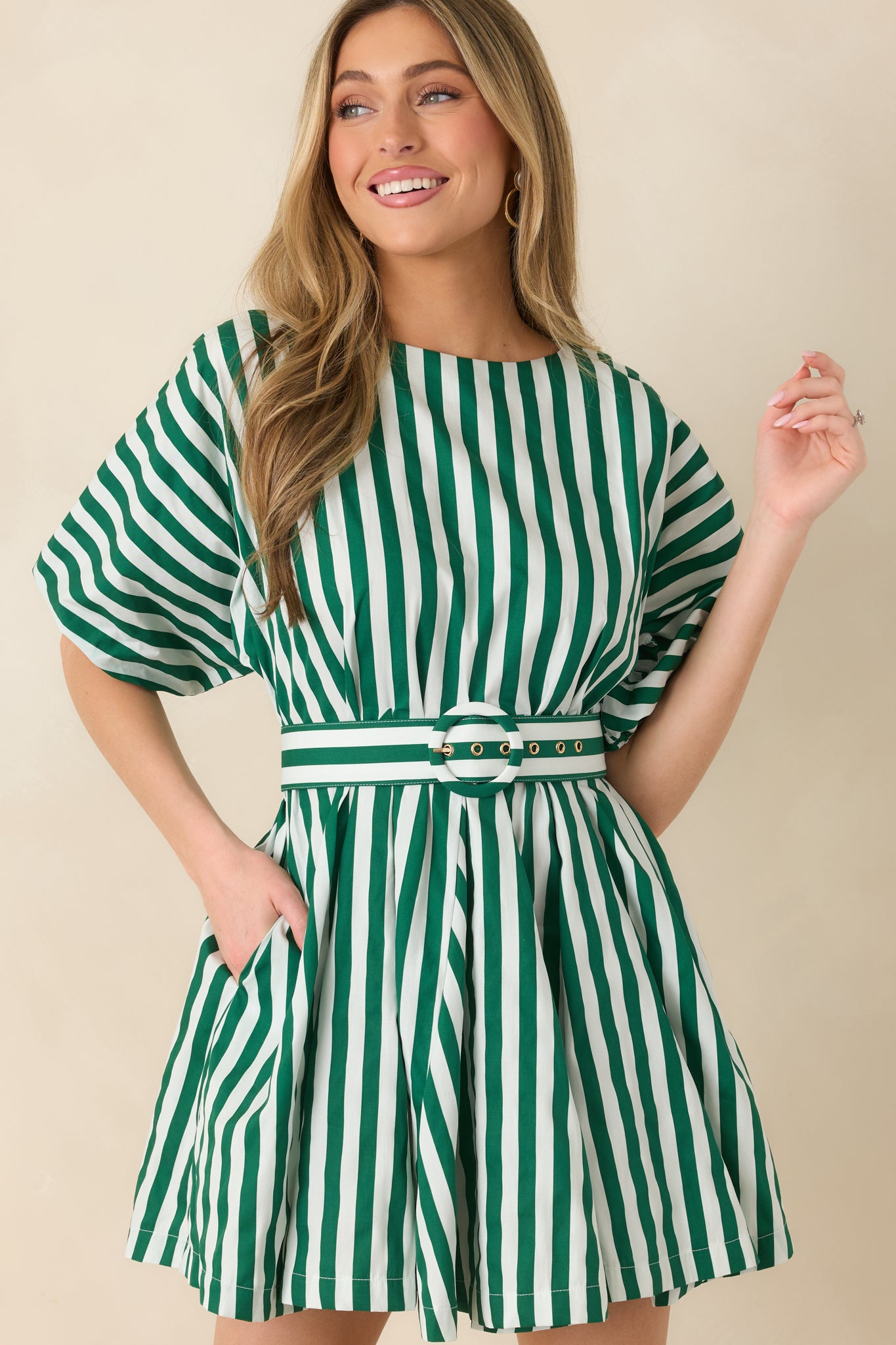 Green and ivory striped dress highlighting the round neckline, softly puffed sleeves, and crisp vertical stripe pattern.