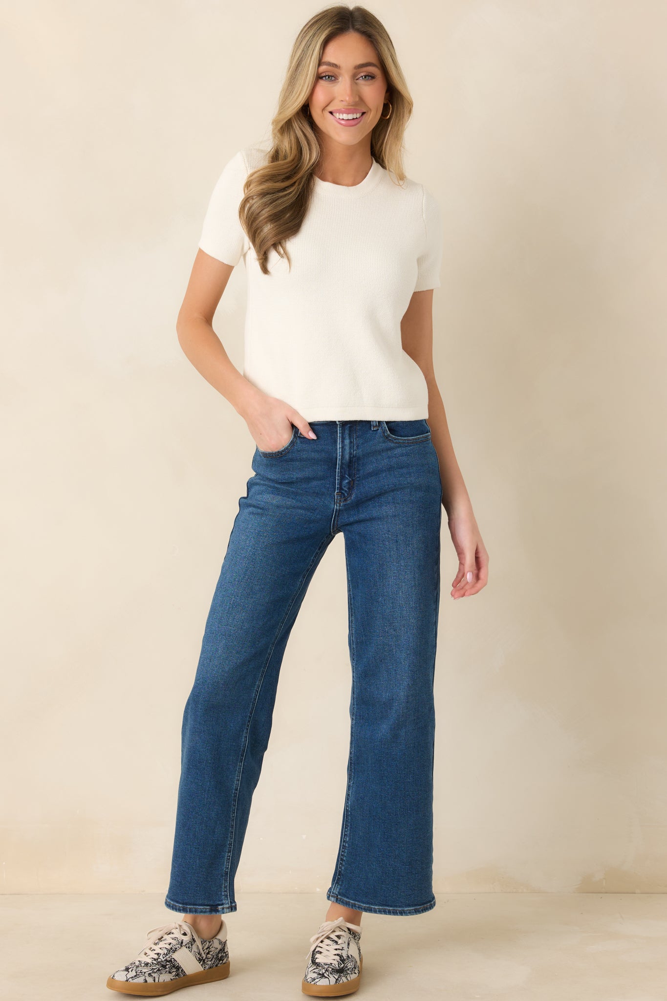 Ivory knit sweater with a classic crew neckline and short sleeves.