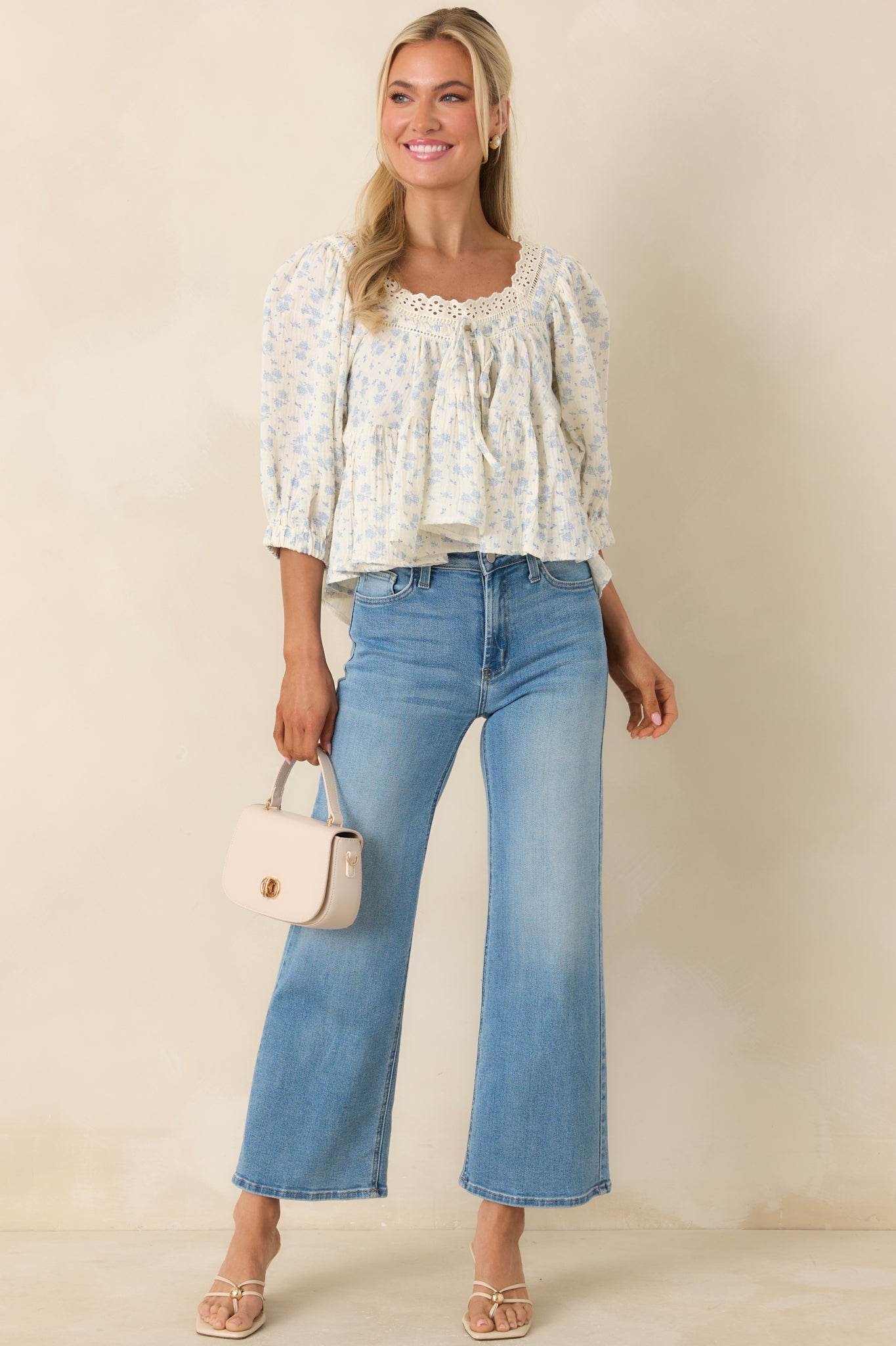 Soft ivory cotton blouse with dainty blue floral print and scalloped eyelet neckline.