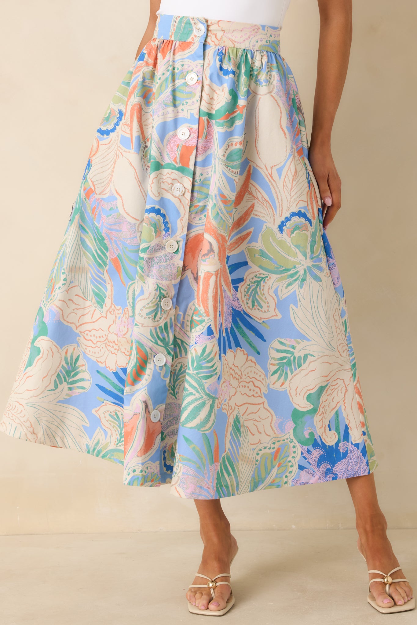 Close view of maxi skirt highlighting button-front placket and soft gathers along the A-line shape.