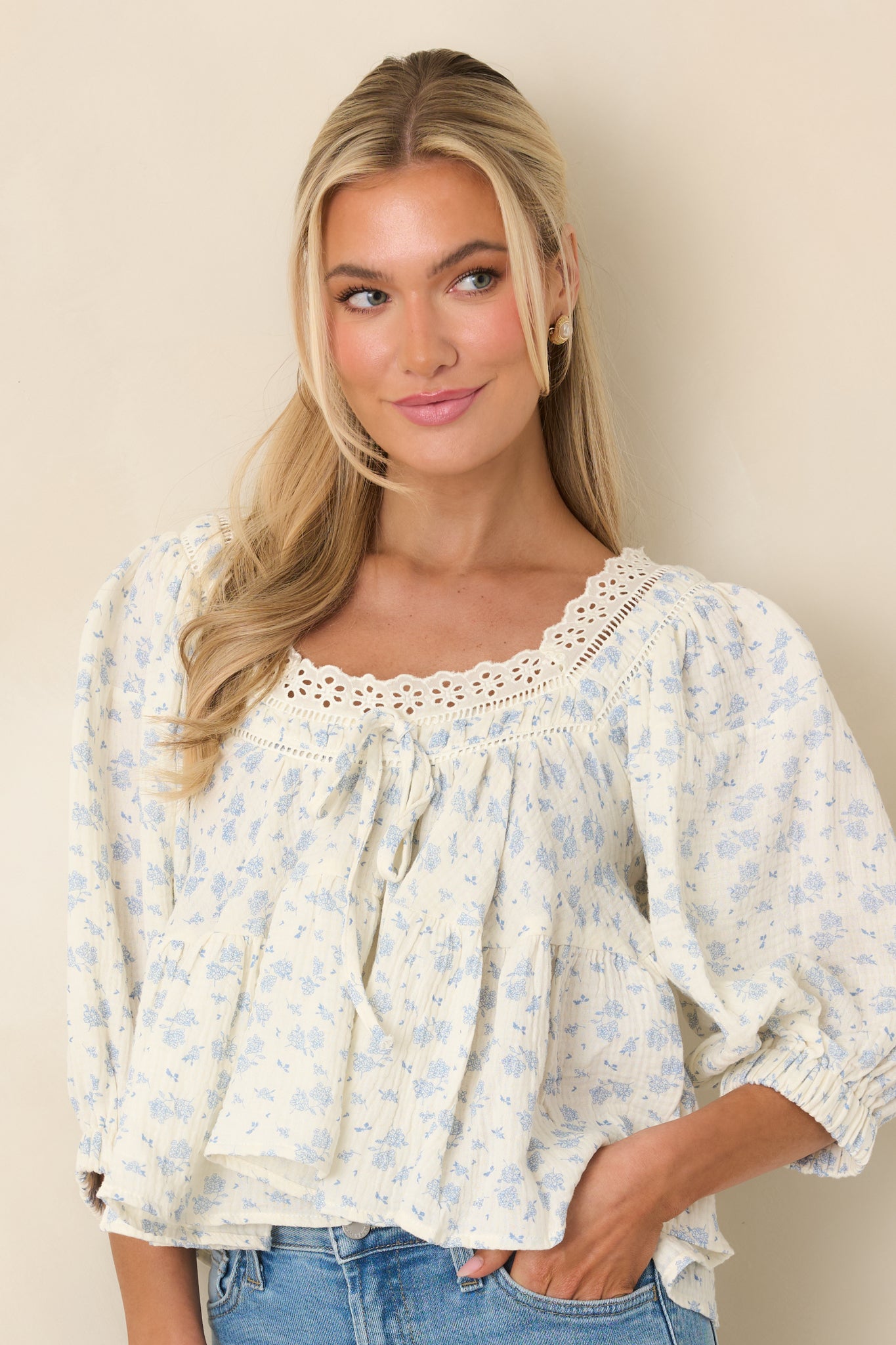 Puffed sleeve detail with tiered bodice and soft cotton fabric texture.