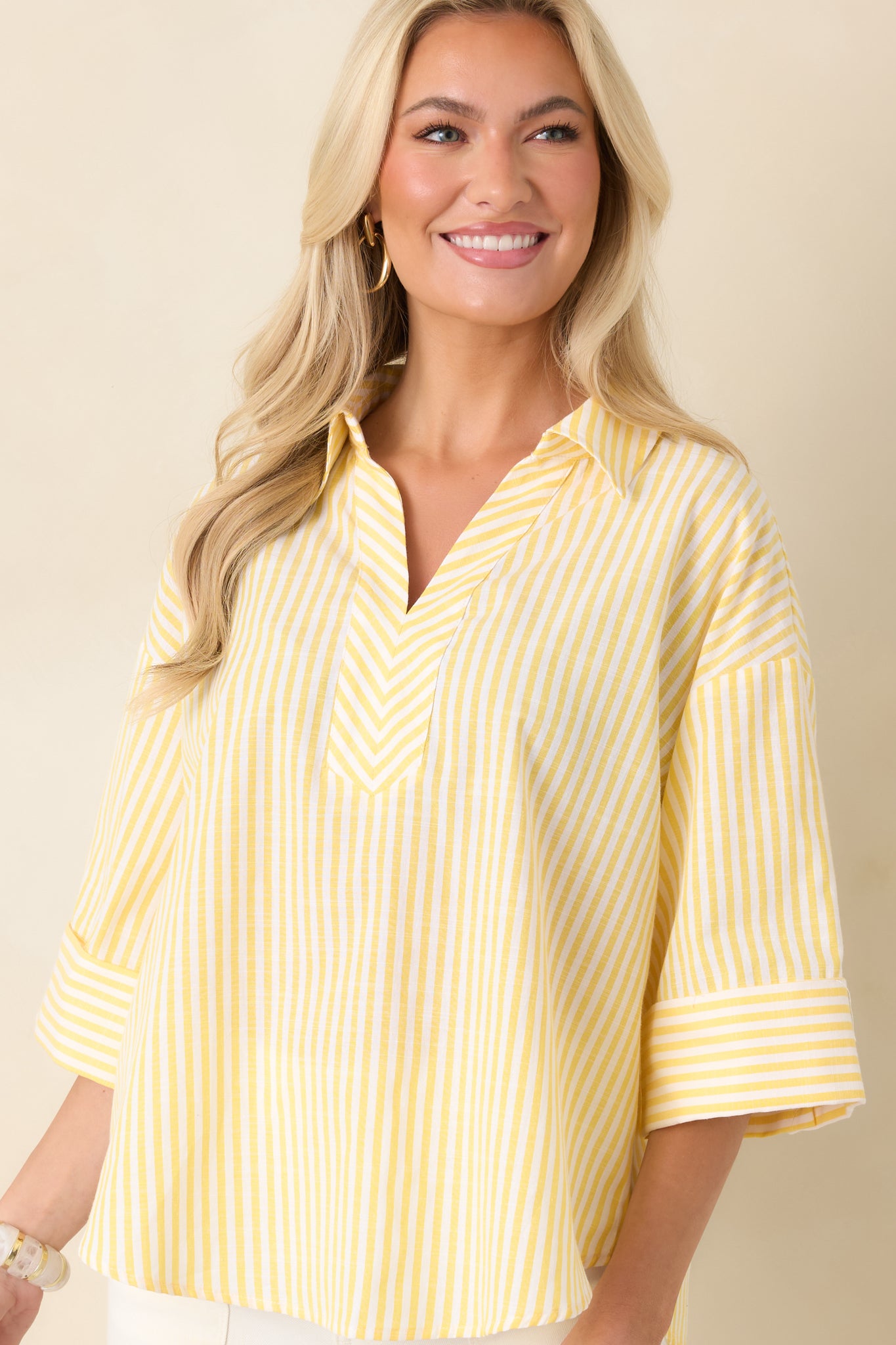  Cropped front view showing the sleeve shape and extended cuff detail of the striped blouse.