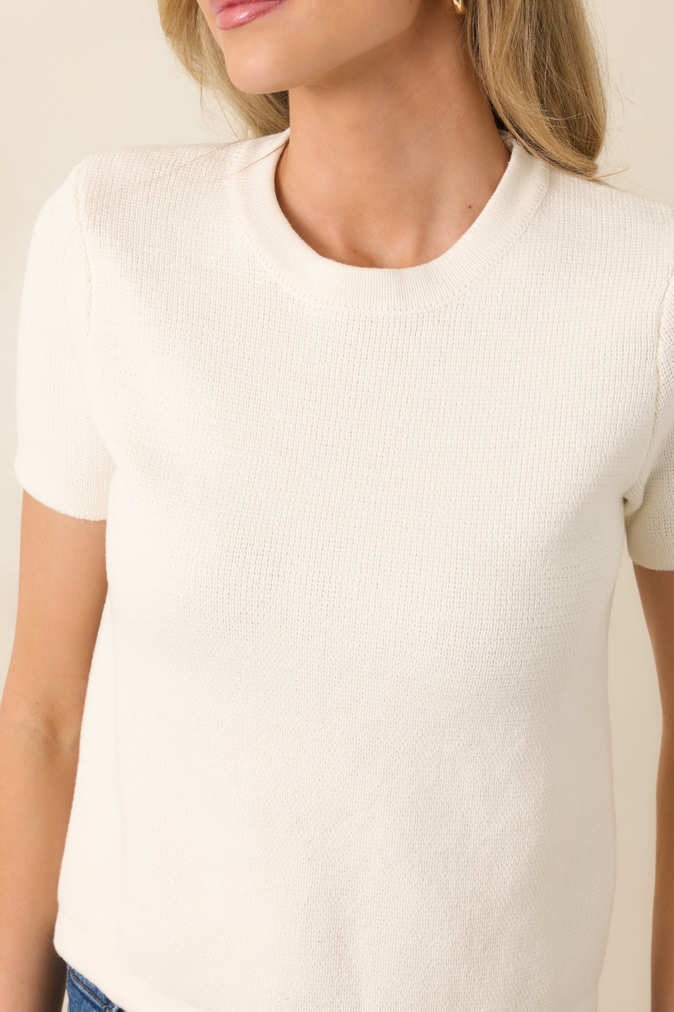Close-up of the ivory knit fabric showcasing its soft texture and subtle weave.