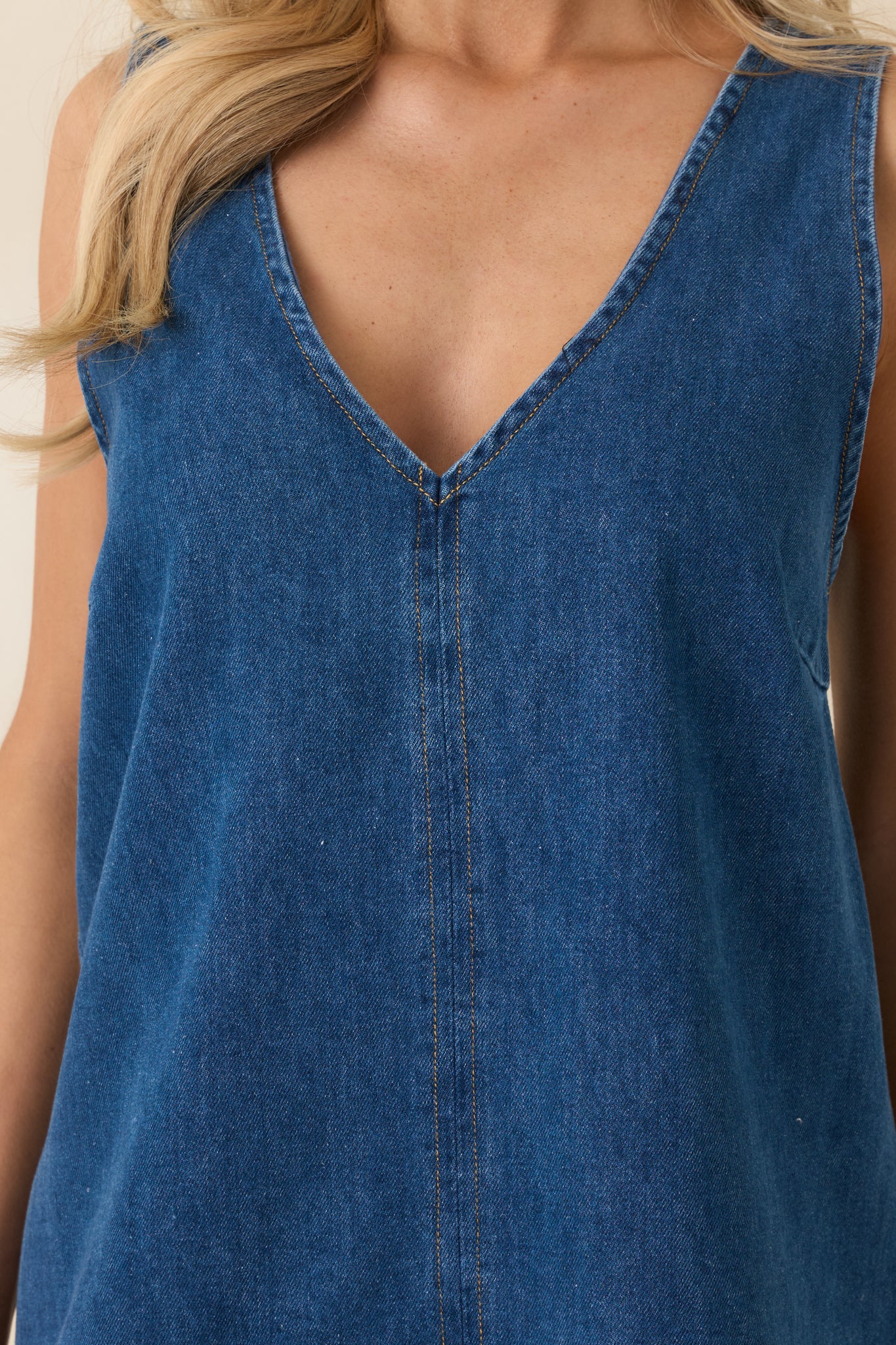 Close-up of the denim mini dress fabric showcasing its soft texture and subtle stitching detail.