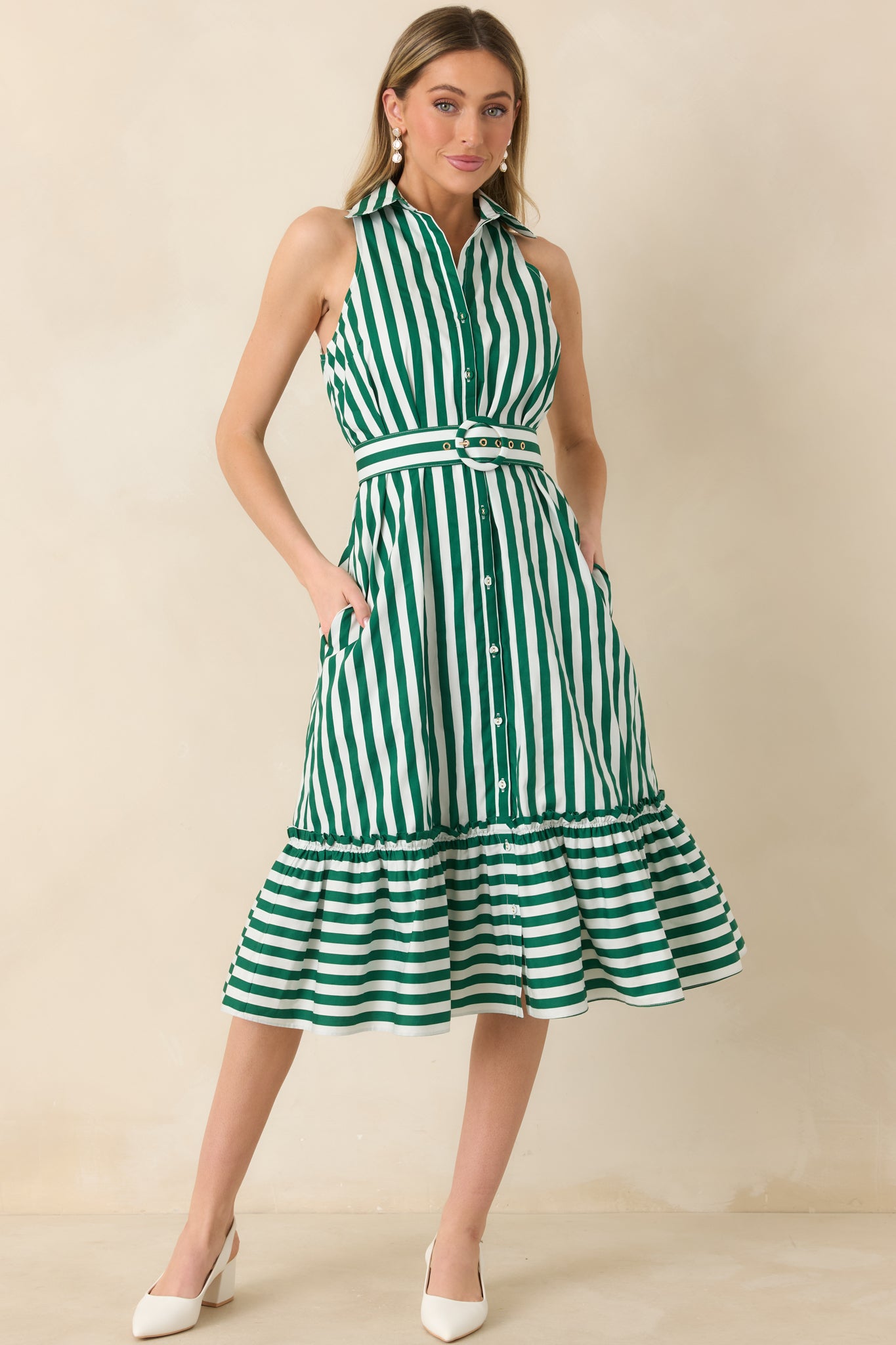 Striped cotton midi dress featuring crisp green and ivory vertical lines, a classic collar, front buttons, and a coordinating belt above a flowing ruffle hem.
