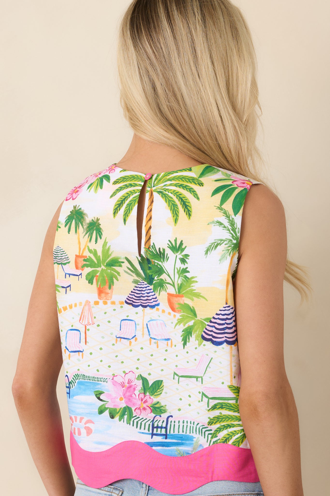 Rear view of the tropical sleeveless top with cropped silhouette and flirty scalloped hem.