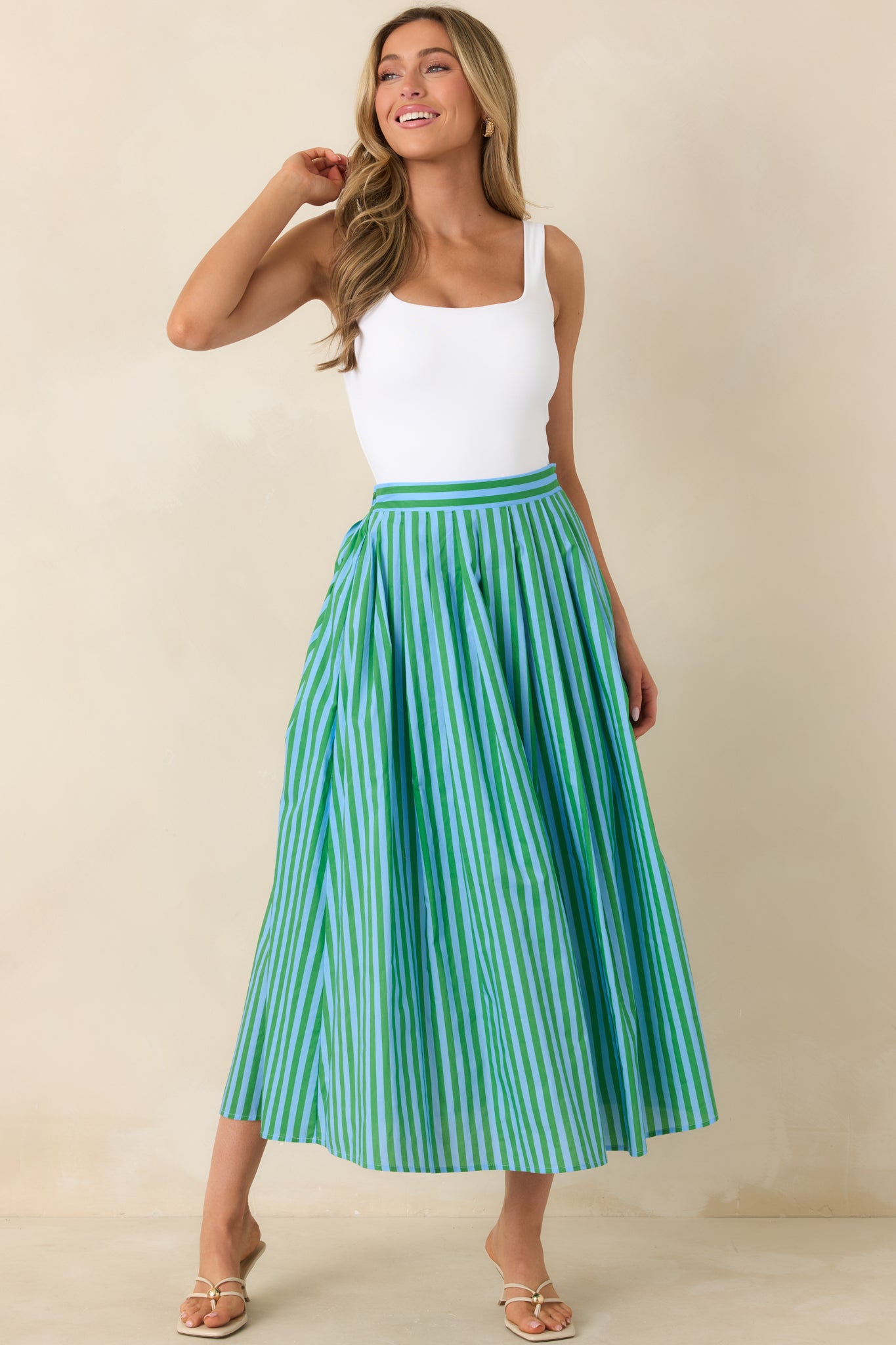 Full-length woven skirt featuring a tailored waistband, vertical stripe pattern, and flowing volume.