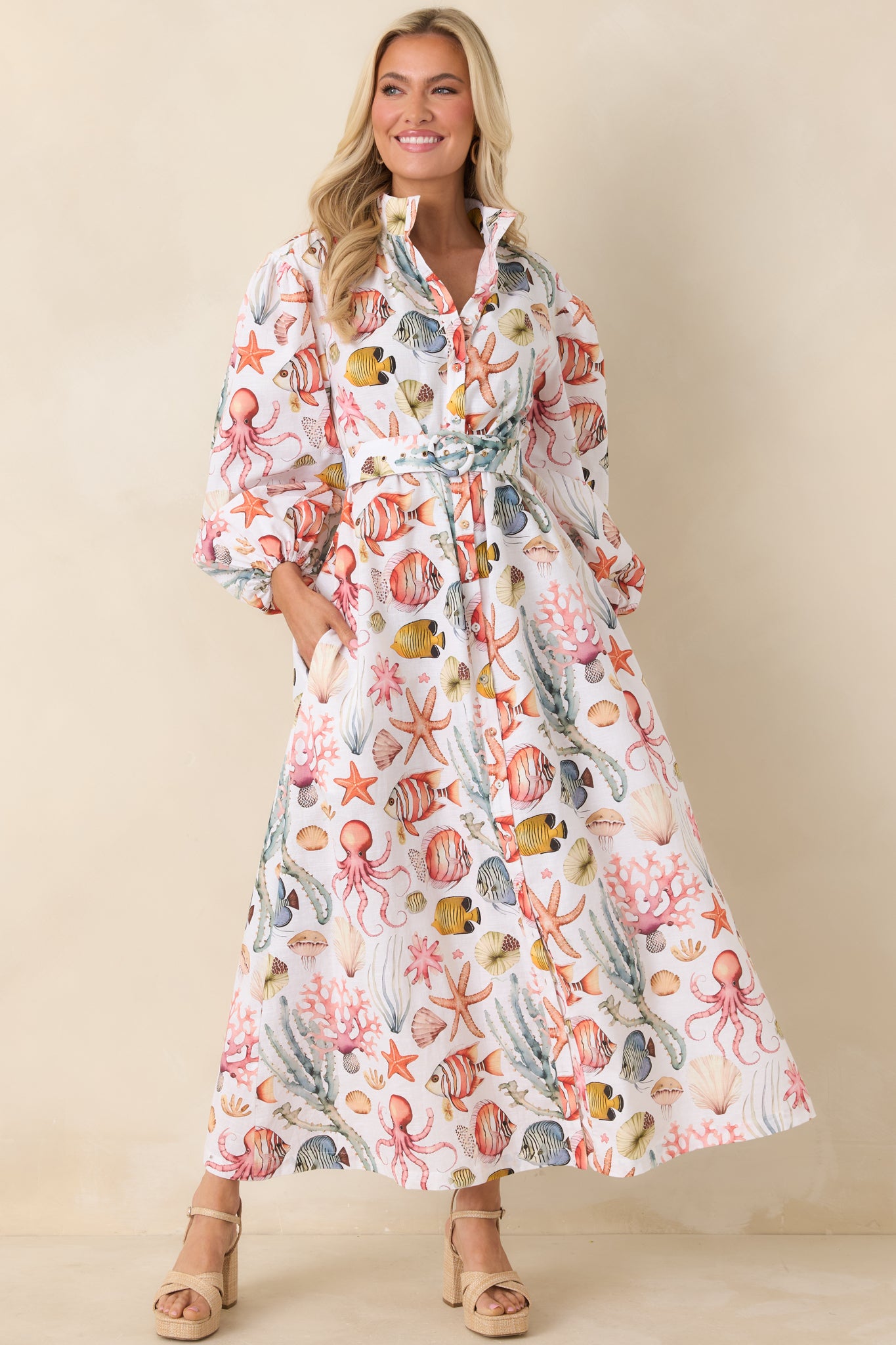 Cotton-linen blend maxi dress featuring a structured silhouette, cinched waist tie, and flowing full-length skirt.