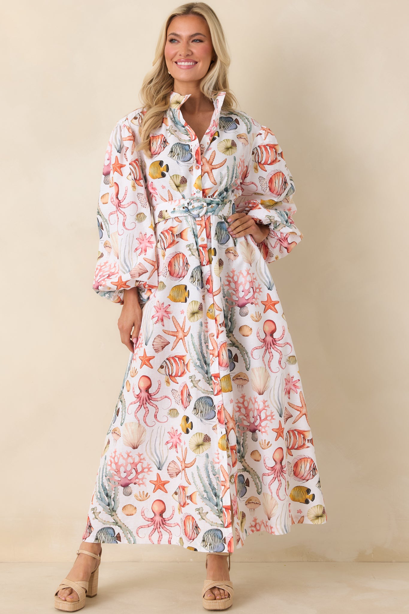 Collared button-down maxi dress with elastic cuffed sleeves, side pockets, and adjustable matching belt.