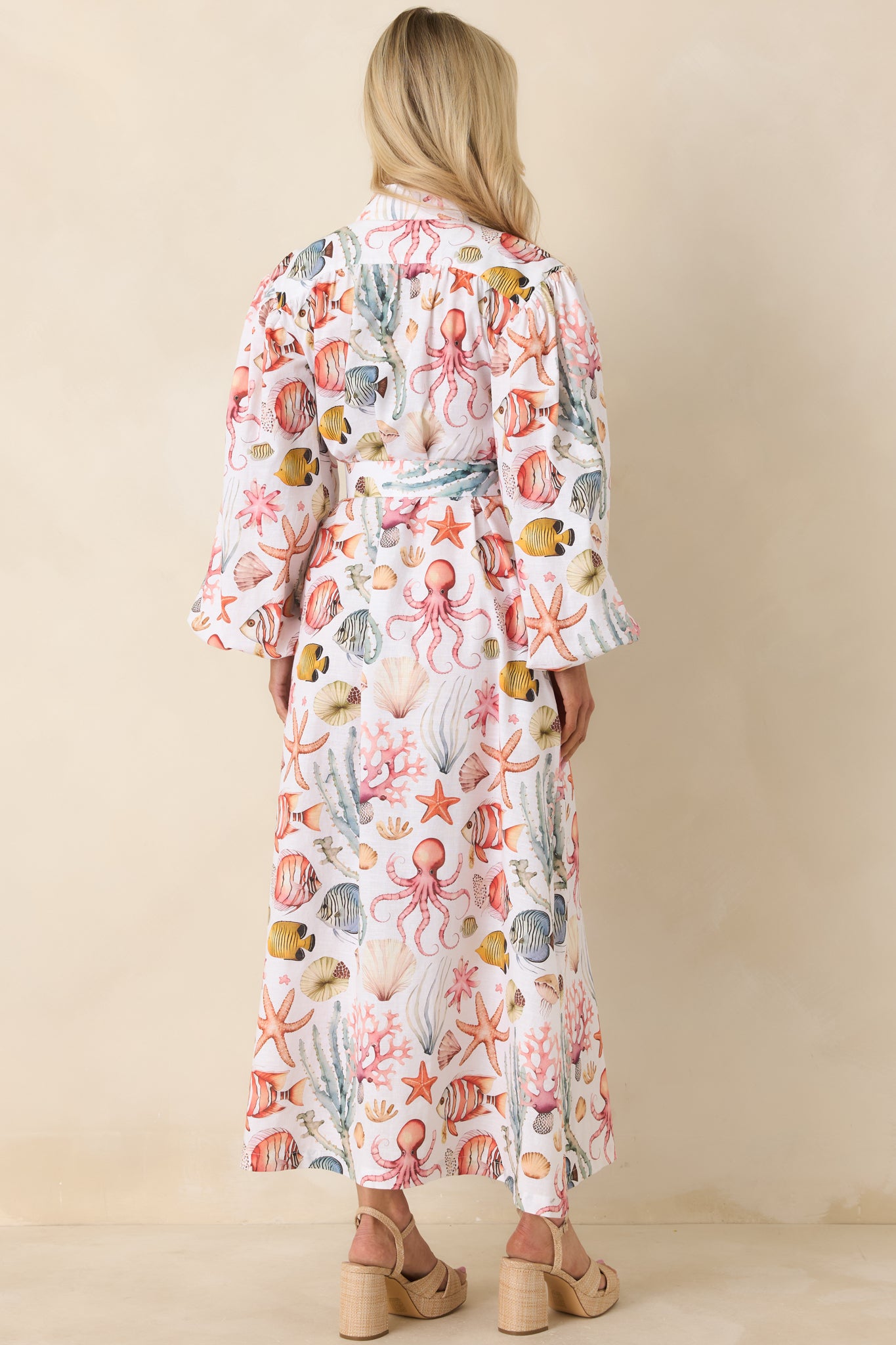 Rear view of maxi dress featuring relaxed full-length silhouette, long sleeves with elastic cuffs, and breathable cotton-linen fabrication.
