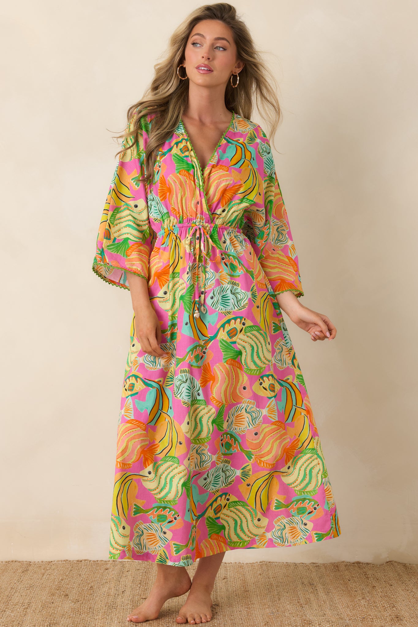 Relaxed-fit dress featuring vibrant fish and ocean-inspired print in pink, green, and orange.