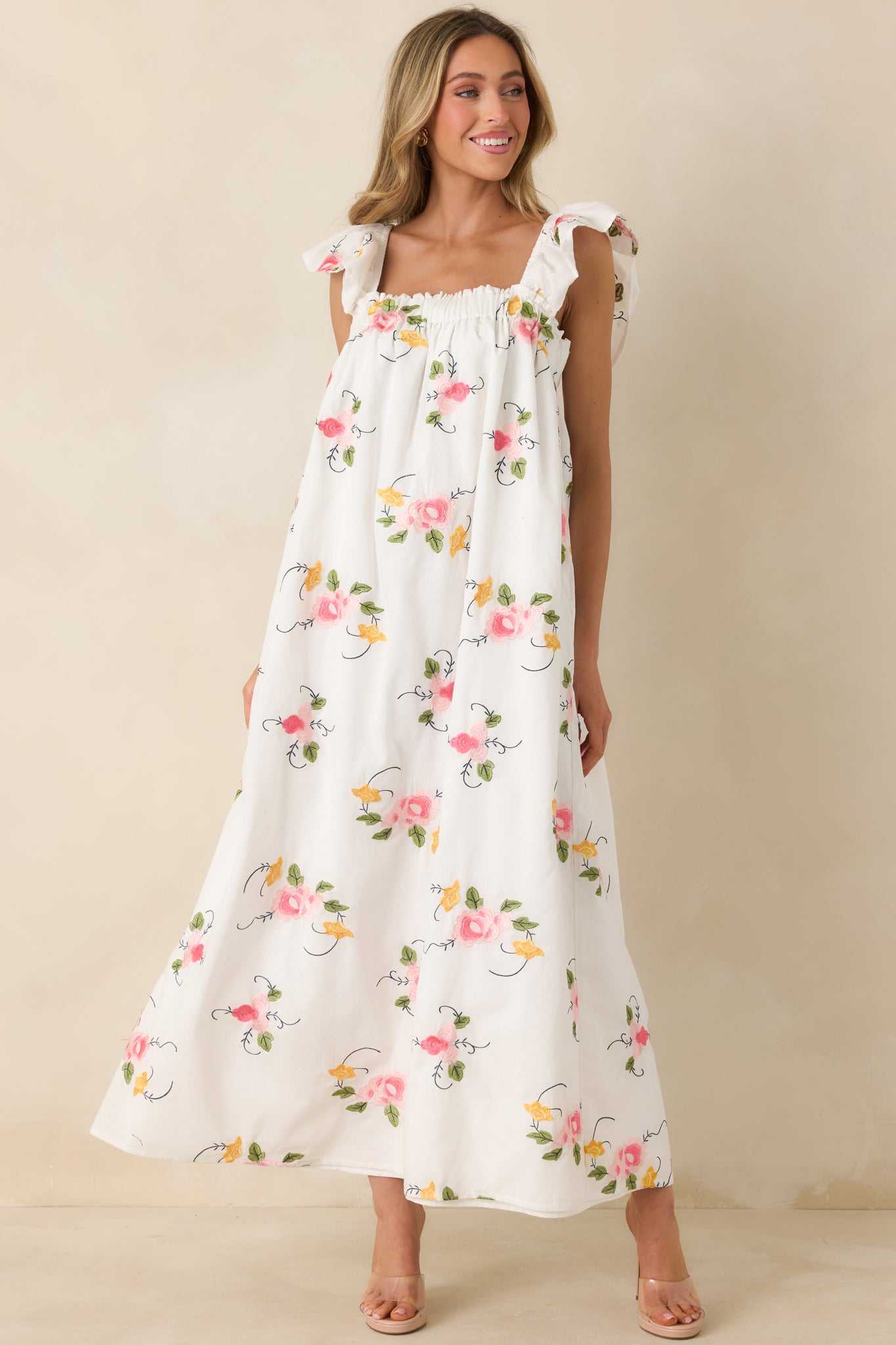 Romantic embroidered maxi with a softly structured bodice, square neckline, and graceful skirt that moves with airy ease.