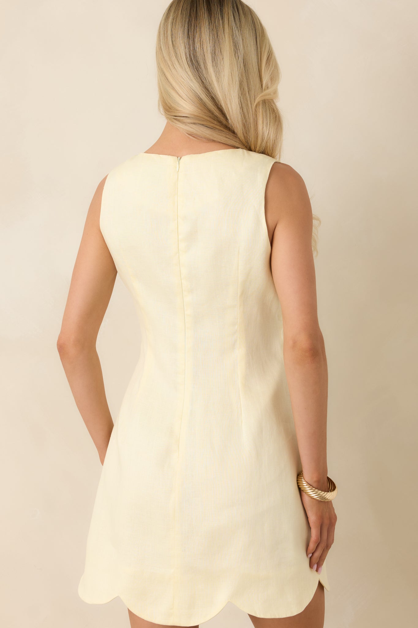 Rear view of linen mini dress with concealed zipper and clean tailored finish.

