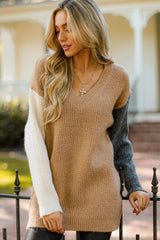 Close up view of this sweater that features a v-neckline, color block design, and an oversized fit.