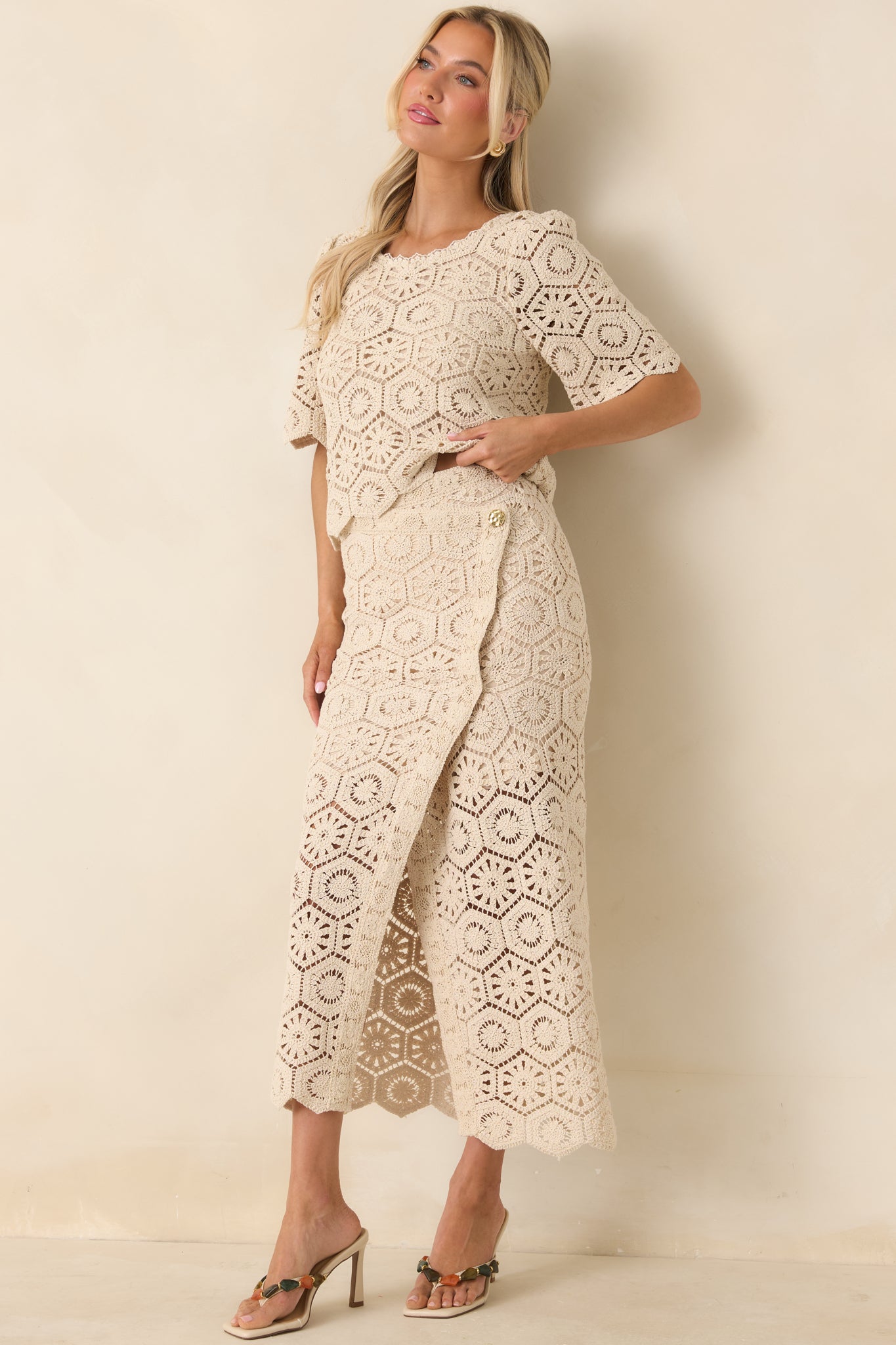Elegant lace top with fitted silhouette, short sleeves, and scalloped edges.
