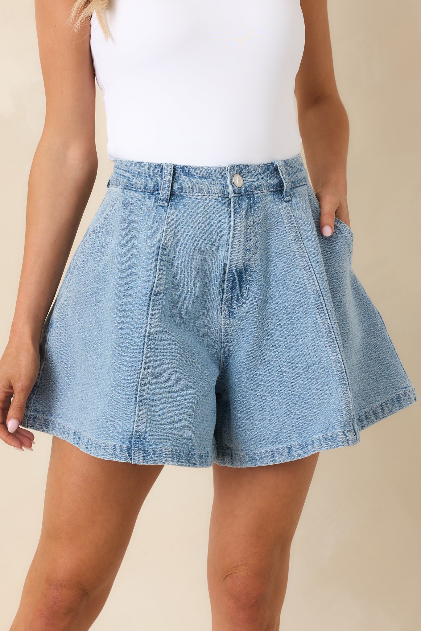 Close view of flared silhouette on lightweight cotton denim shorts.