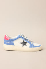 Full side view of these sneakers that feature a rounded toe, functional laces, medium wash denim trim, silver stars, and neon pink detailing.