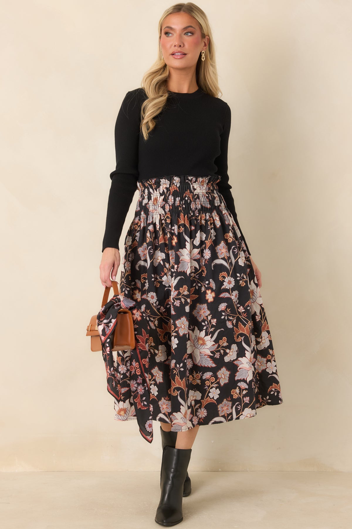 Black floral cotton midi skirt with ivory, blush, rust, and periwinkle blooms, a smocked waistband, and a full A-line silhouette.