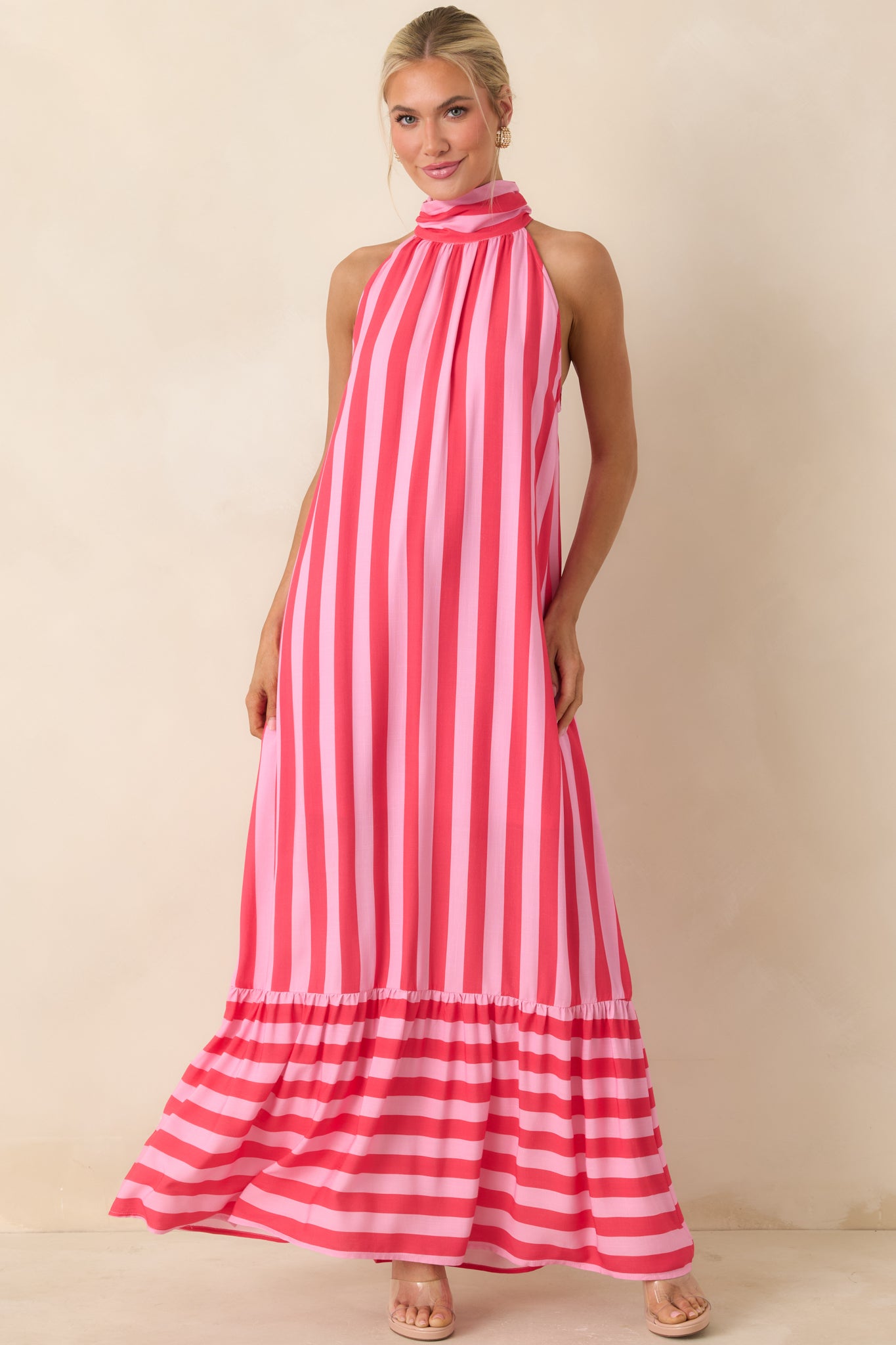 Fuchsia and light pink striped halter dress with a gathered neckline and relaxed flowing silhouette.