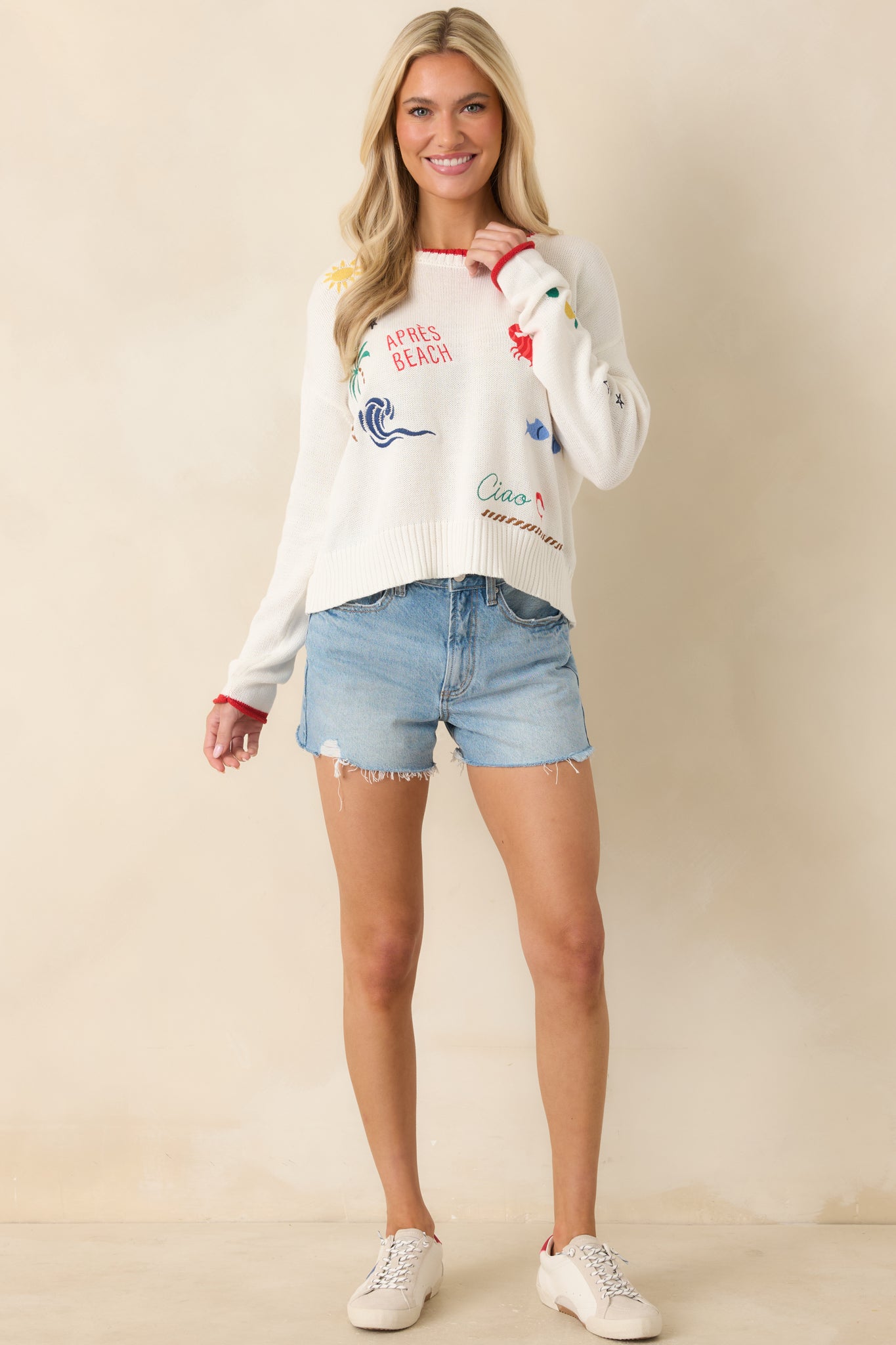 Lightweight striped crochet sweater featuring dropped shoulders, long sleeves, ribbed cuffs, and a breathable open-knit texture with a beachy feel.