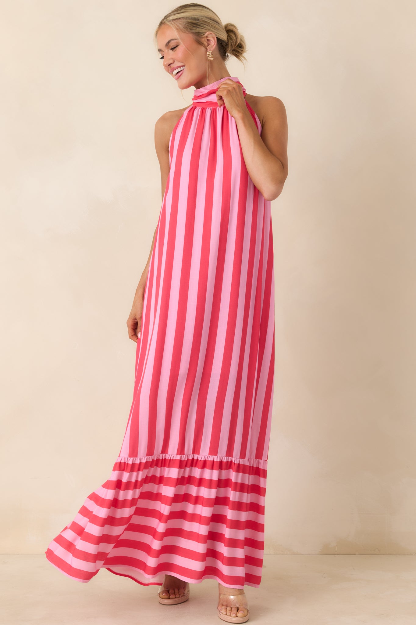 Bright striped halter dress with a loose silhouette and tiered hem with horizontal stripe contrast.
